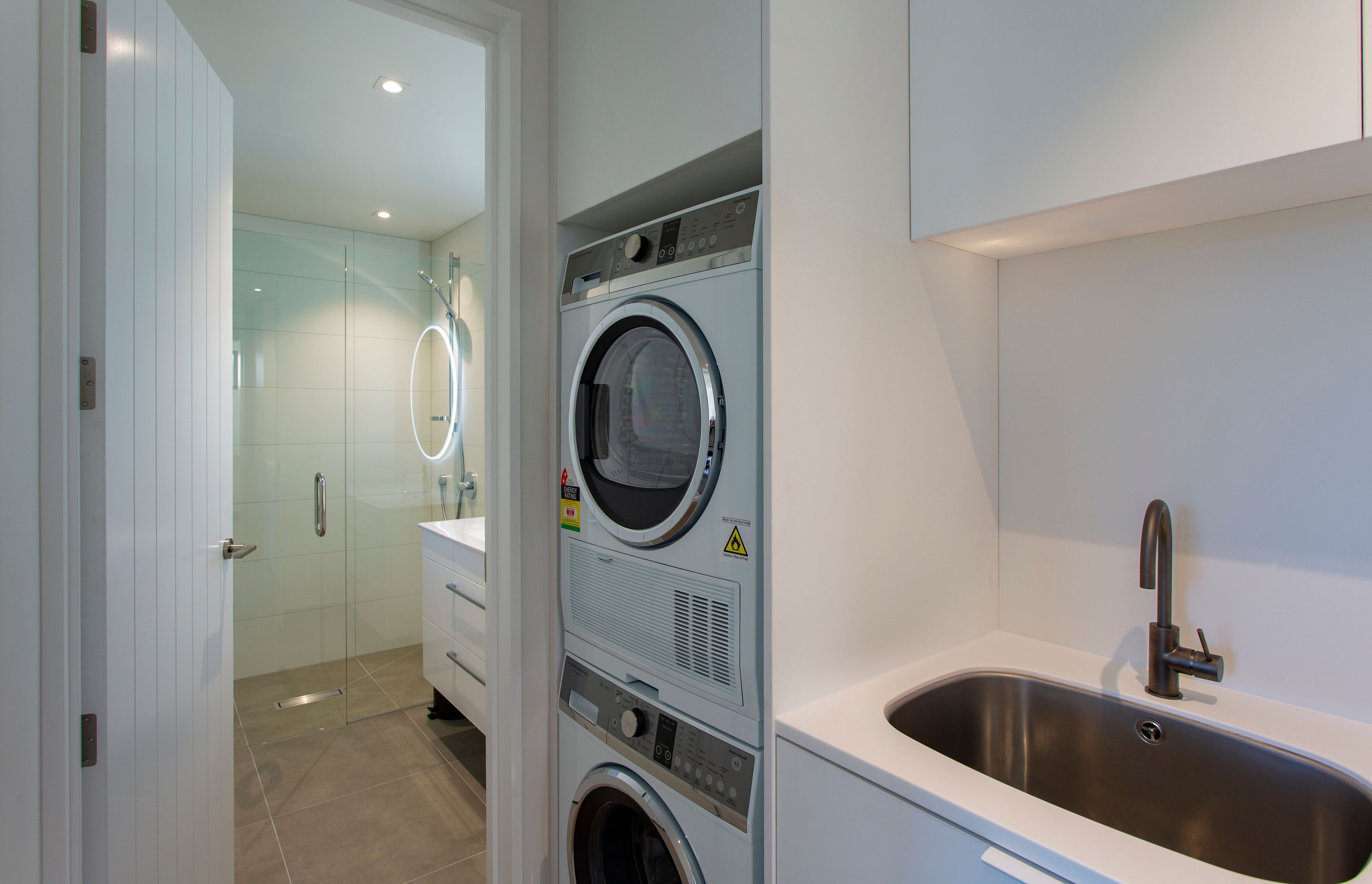 Compact laundry using F&P stacker washer and dryer combo.