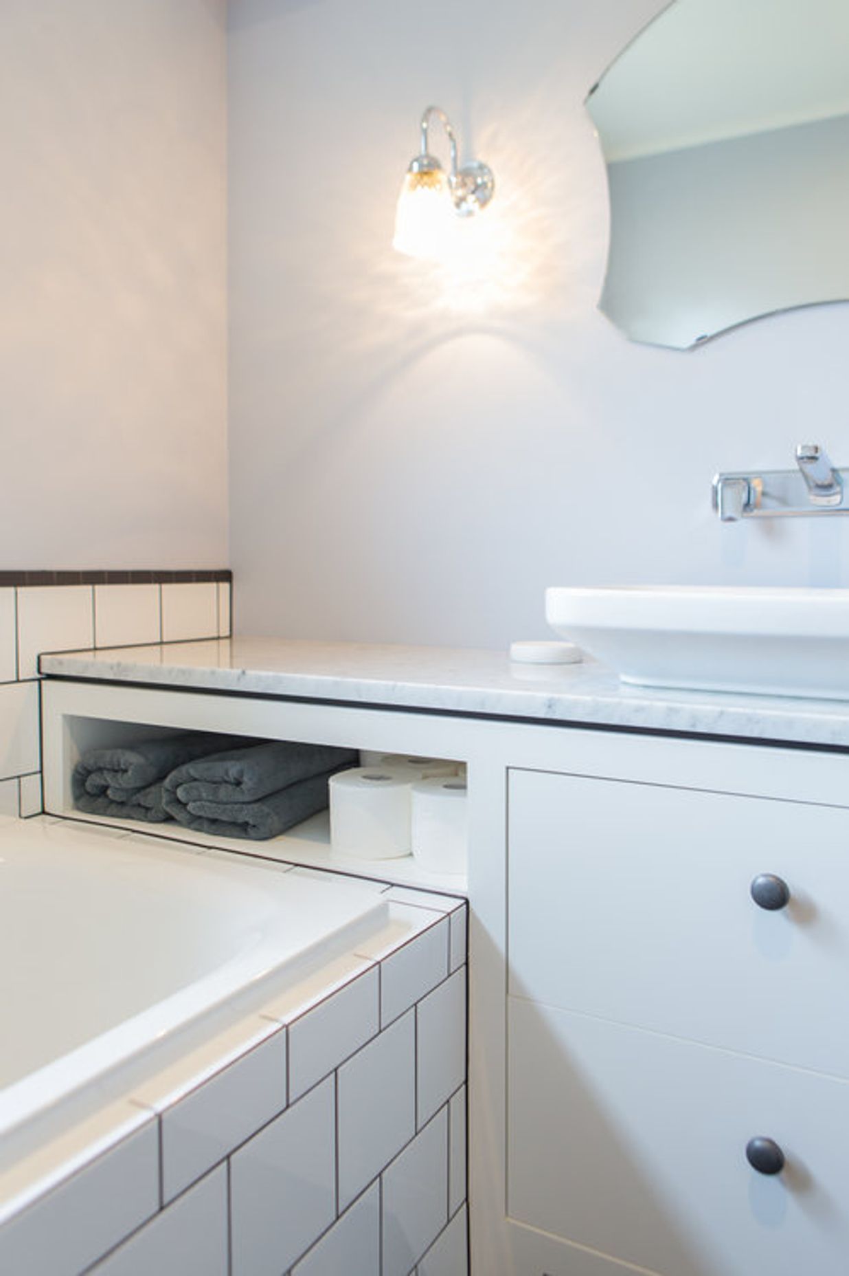 Generous vanity bench space also creates extra storage in this small bathroom.