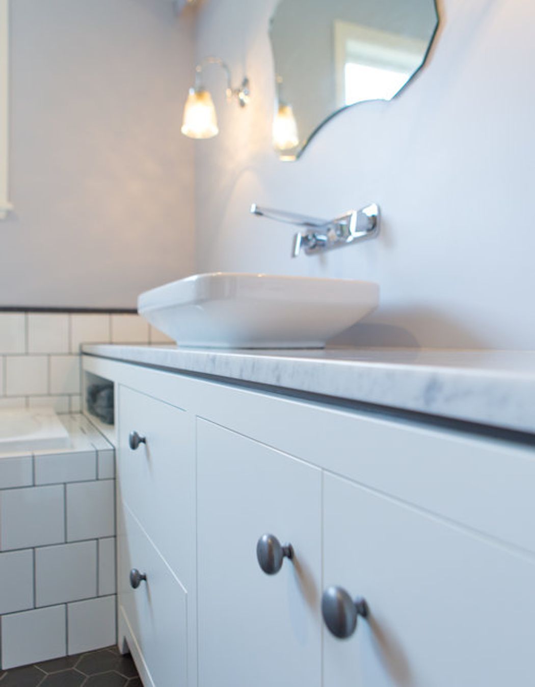 Sweet pewter handles and a dark negative detail on the vanity.