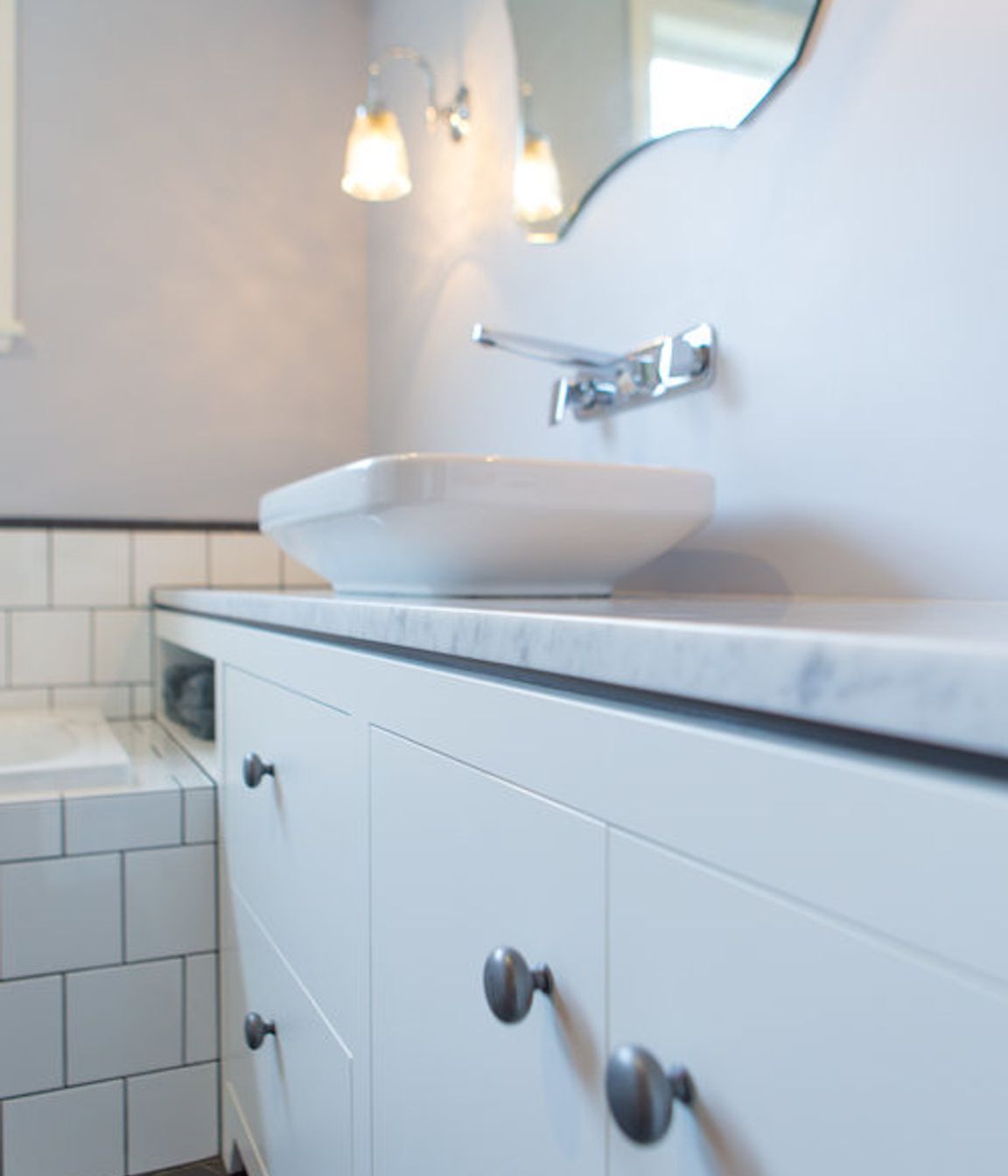 Sweet pewter handles and a dark negative detail on the vanity.