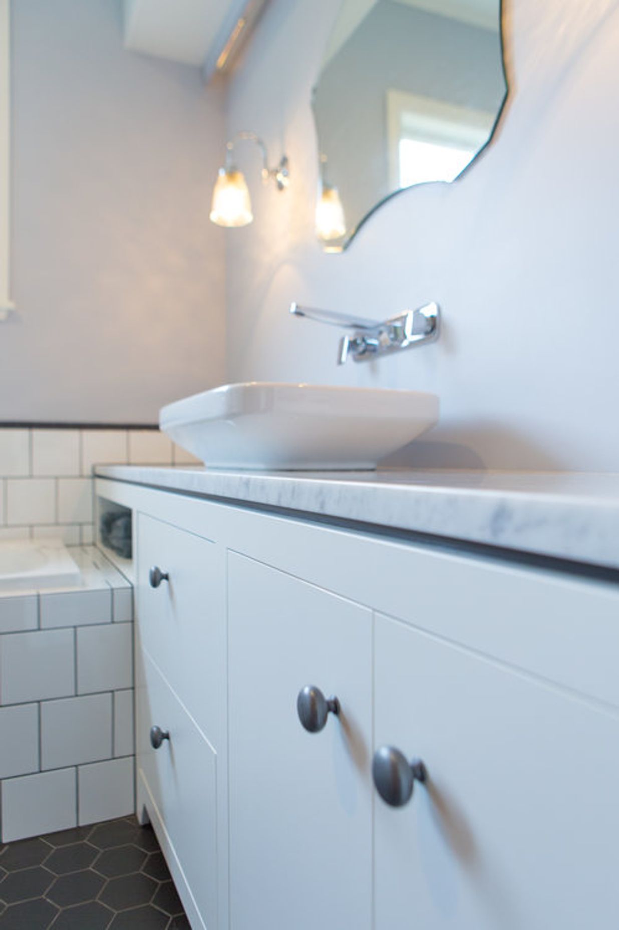 Sweet pewter handles and a dark negative detail on the vanity.