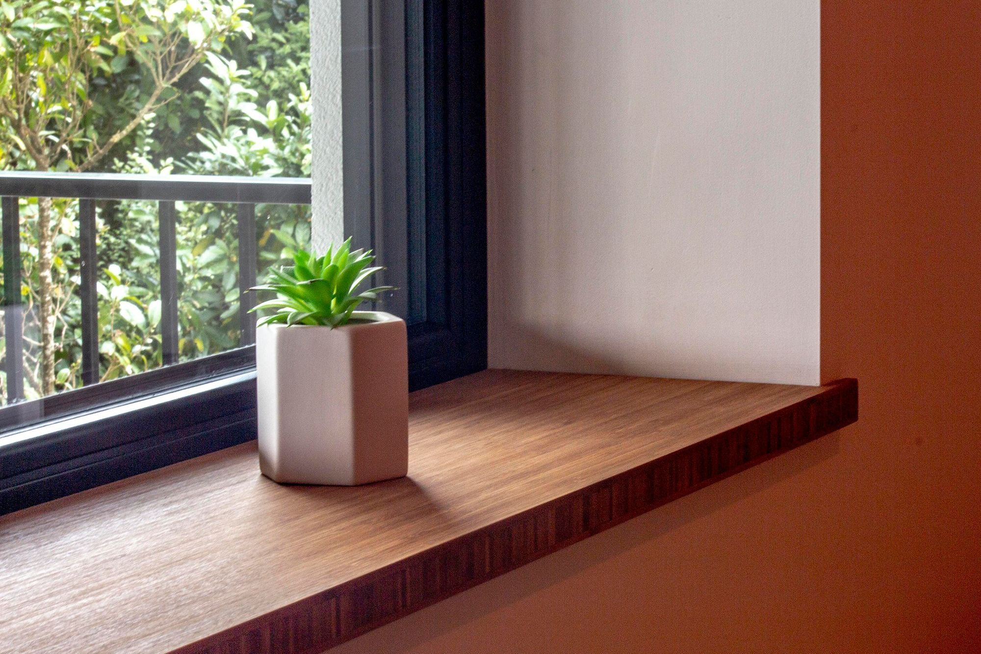 Bamboo window sill below the triple-glazed windows.