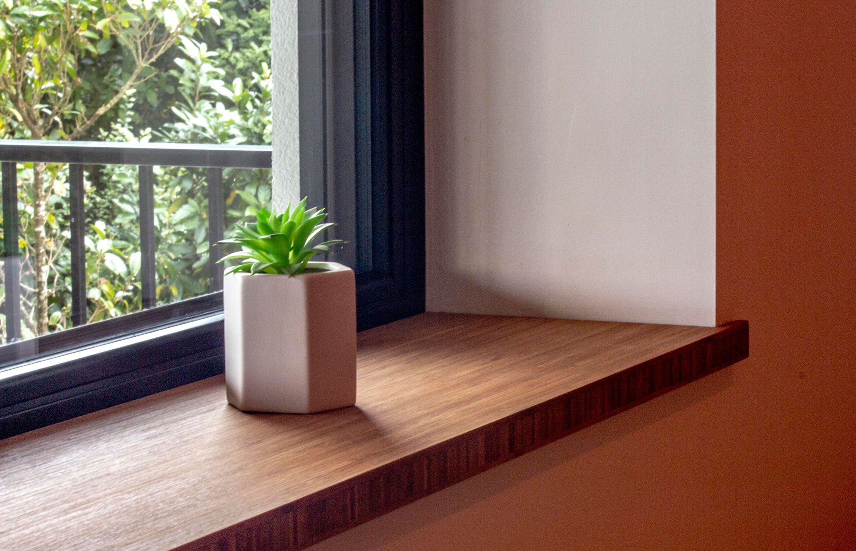 Bamboo window sill below the triple-glazed windows.