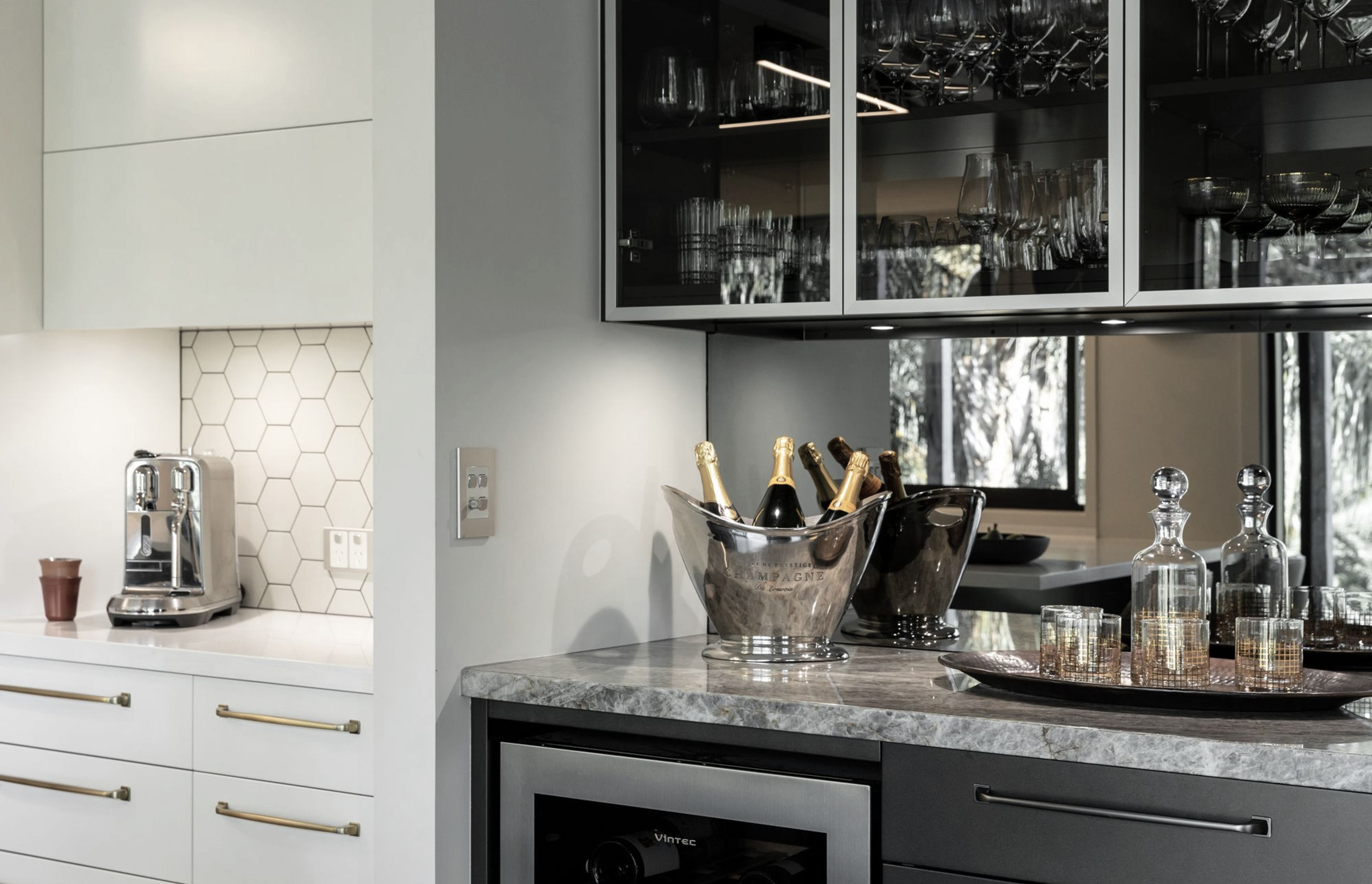 A coffee and drinks zone were added for clients who like to entertain. The bar includes a drinks fridge and plenty of space for their wine glasses collection. This extends and enhances the kitchen space and allows guests to feel connected pouring drinks y