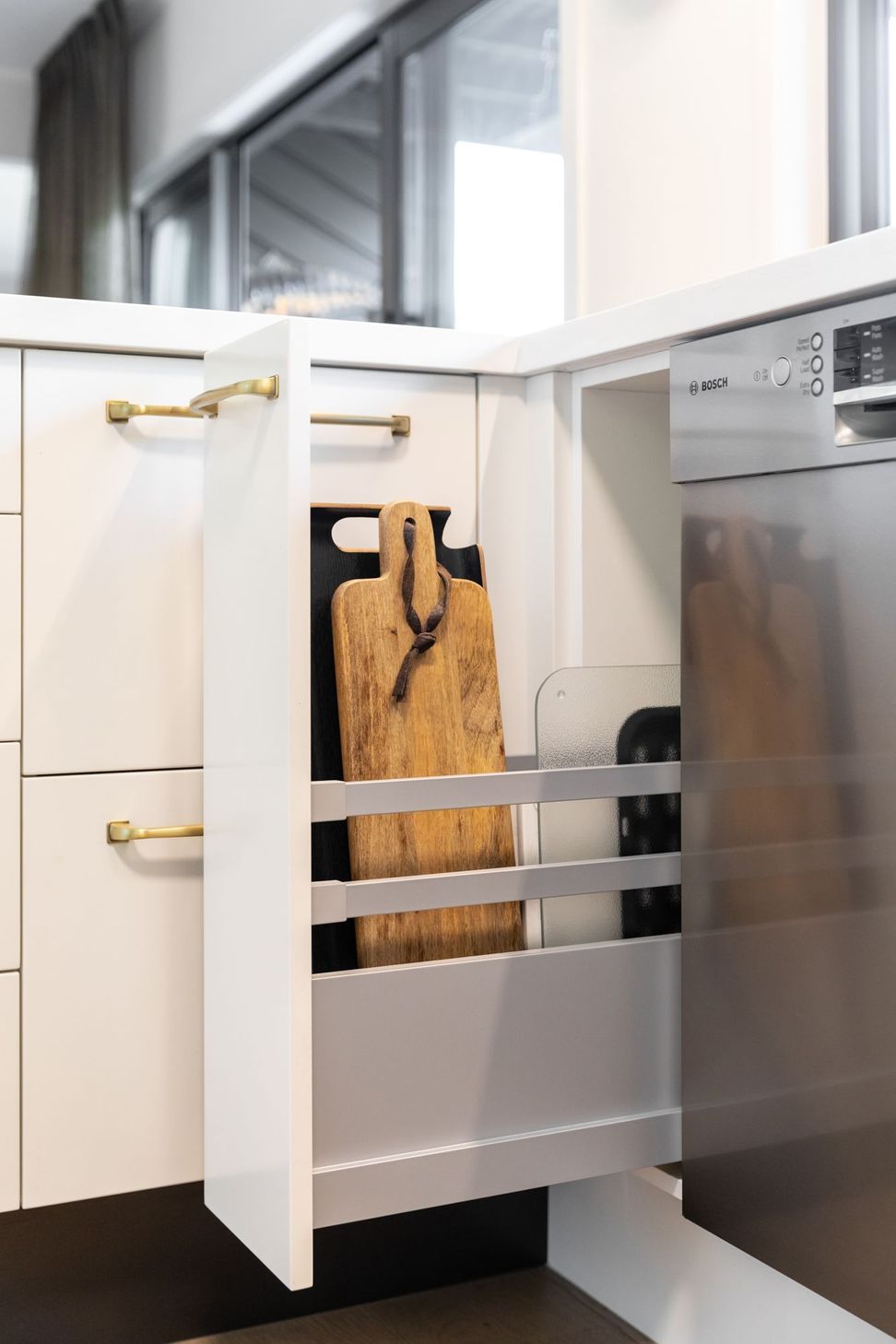 Large breadboards and trays are allocated to this narrow pullout utilising Häfele's high Grass runners & rails giving stability.