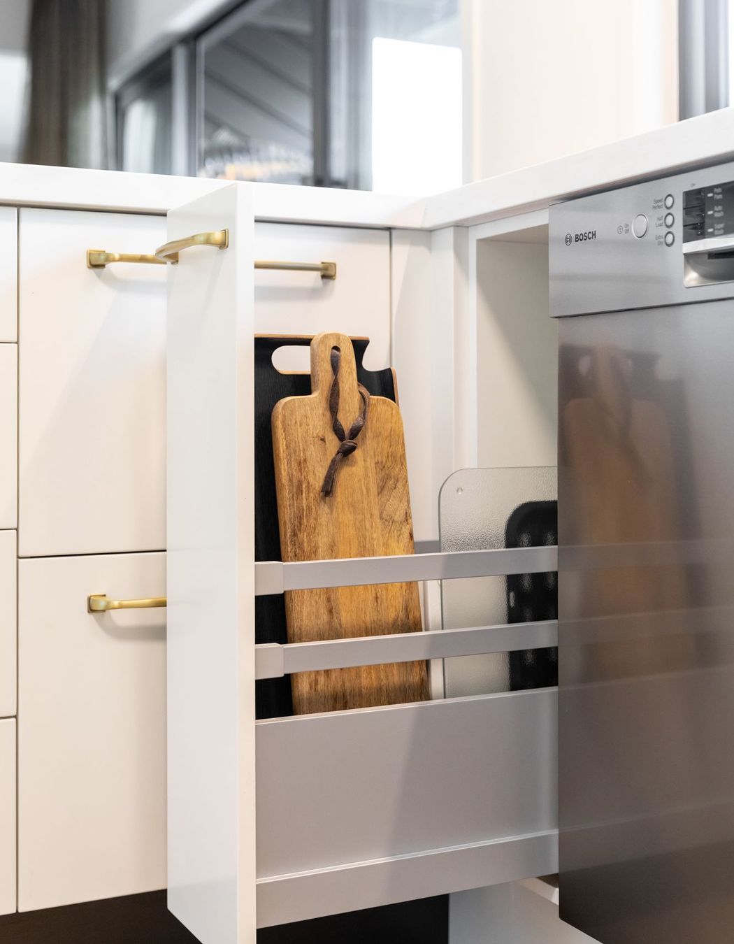 Large breadboards and trays are allocated to this narrow pullout utilising Häfele's high Grass runners & rails giving stability.