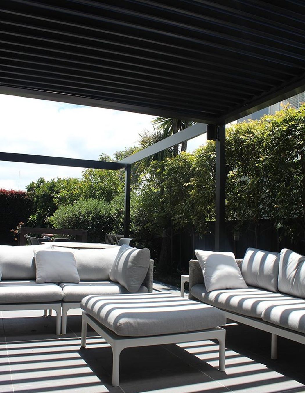 The north facing courtyard tucked in between lush hedging and the dining area create a private and intimate outdoor dining experience. Louvres over this space provide shade and shelter but slide away to one side should one wish for more sun.