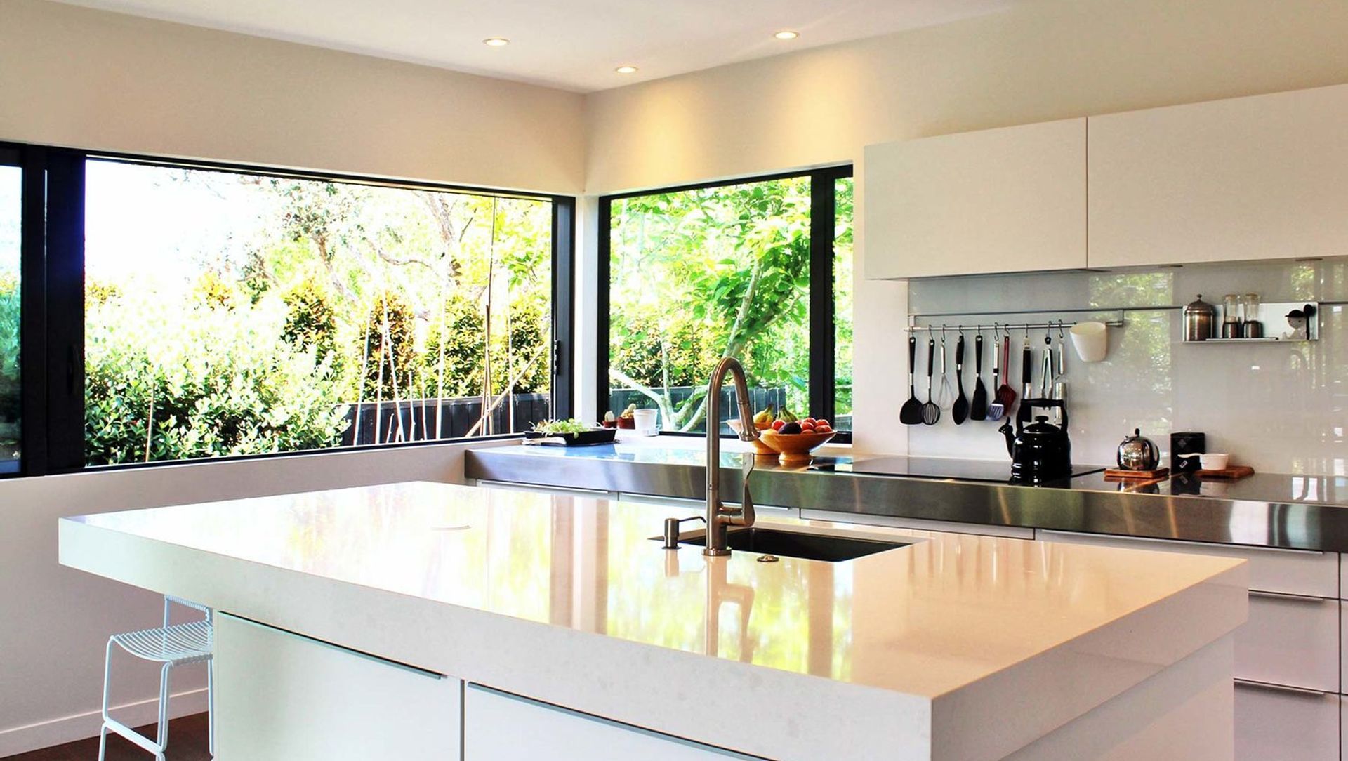 The kitchen is also bathed in light with large sliding windows opening the kitchen to the vege garden outside and drenching the island bench with sunlight.