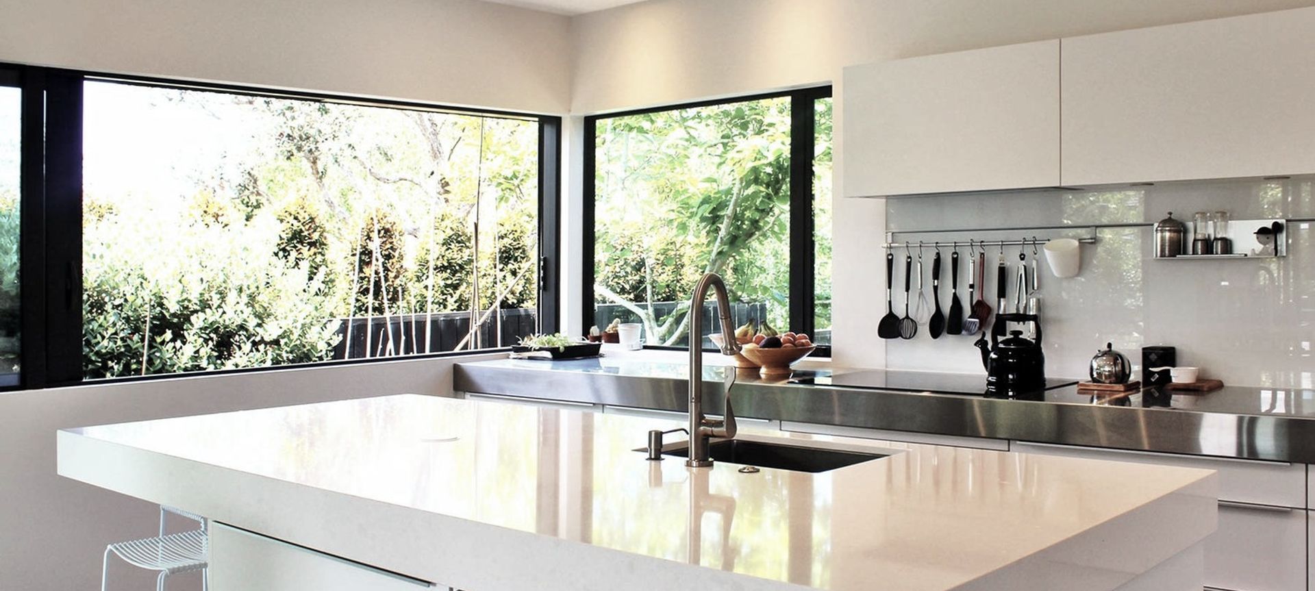 The kitchen is also bathed in light with large sliding windows opening the kitchen to the vege garden outside and drenching the island bench with sunlight.  