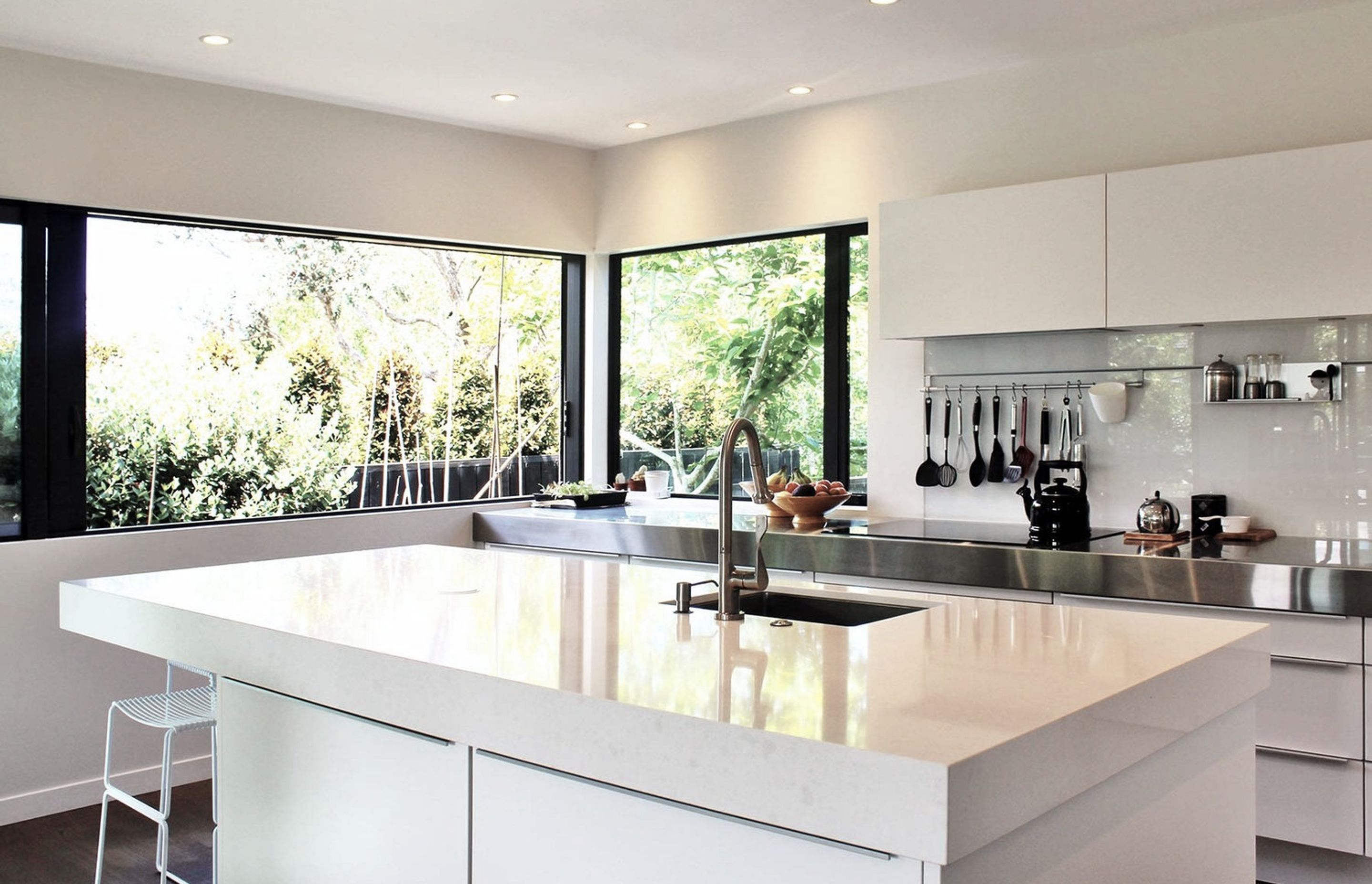 The kitchen is also bathed in light with large sliding windows opening the kitchen to the vege garden outside and drenching the island bench with sunlight.