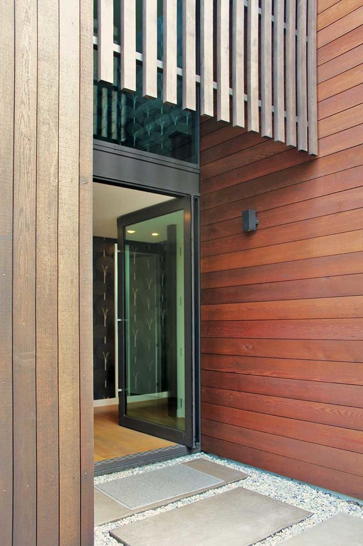 A double height glazed entry lets light penetrate the central hallway or circulation zone.