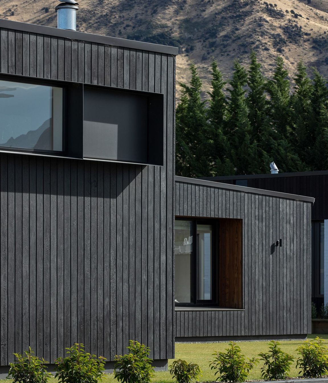 Charred Abodo wood cladding provides a contrast to the cedar-clad homes.