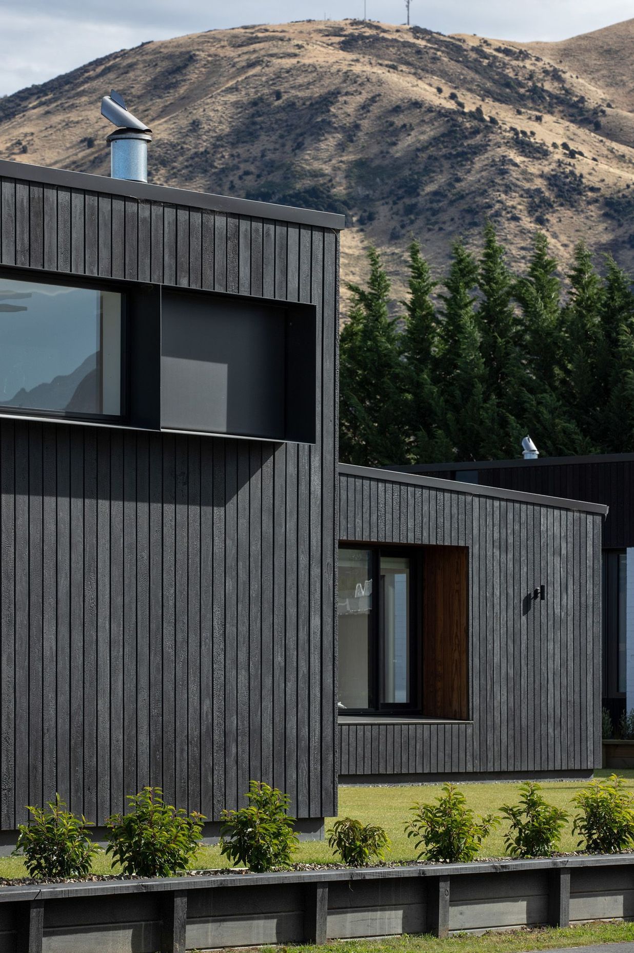 Charred Abodo wood cladding provides a contrast to the cedar-clad homes.