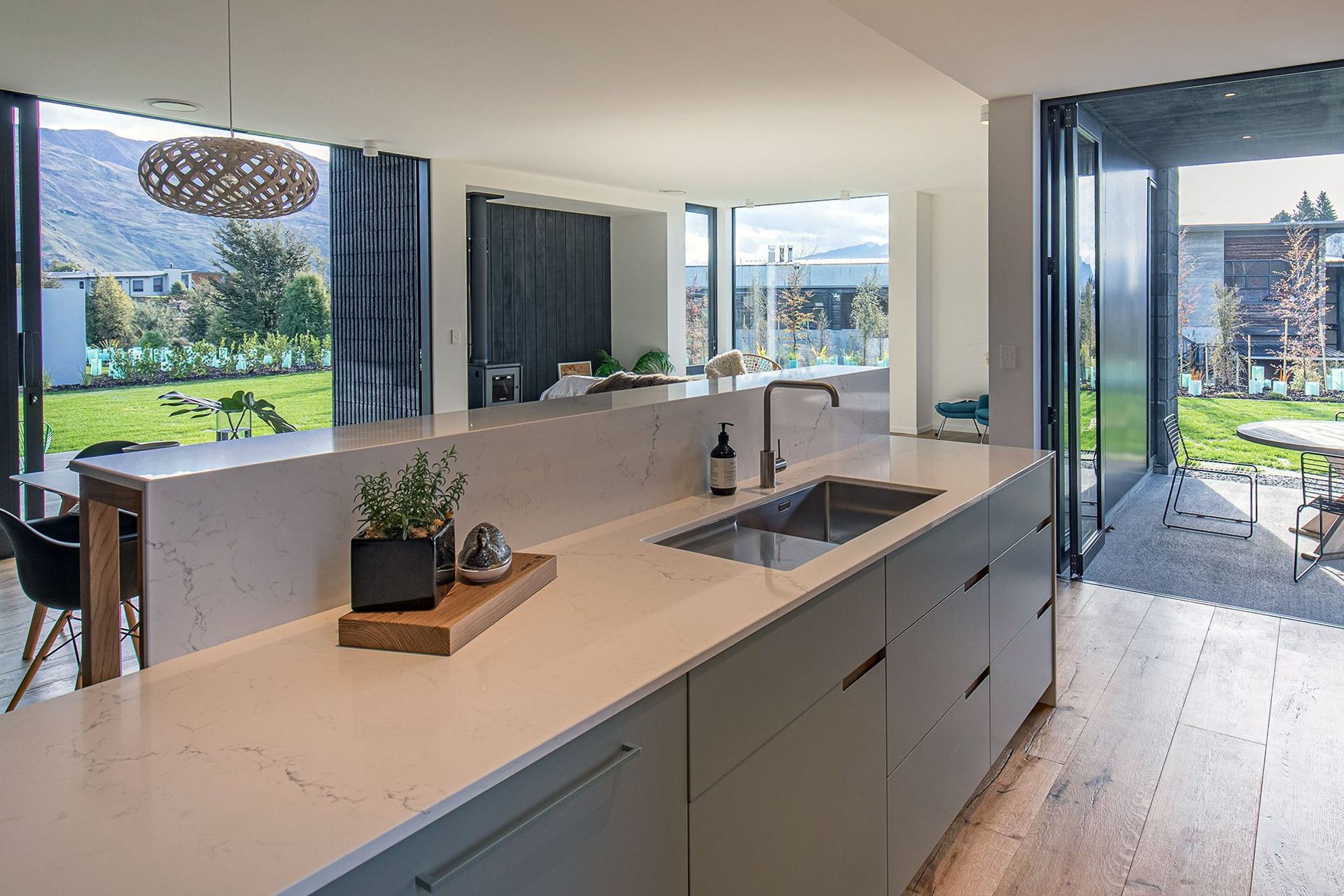 The open-plan kitchen, dining and living area opens up on all sides to the outdoors.