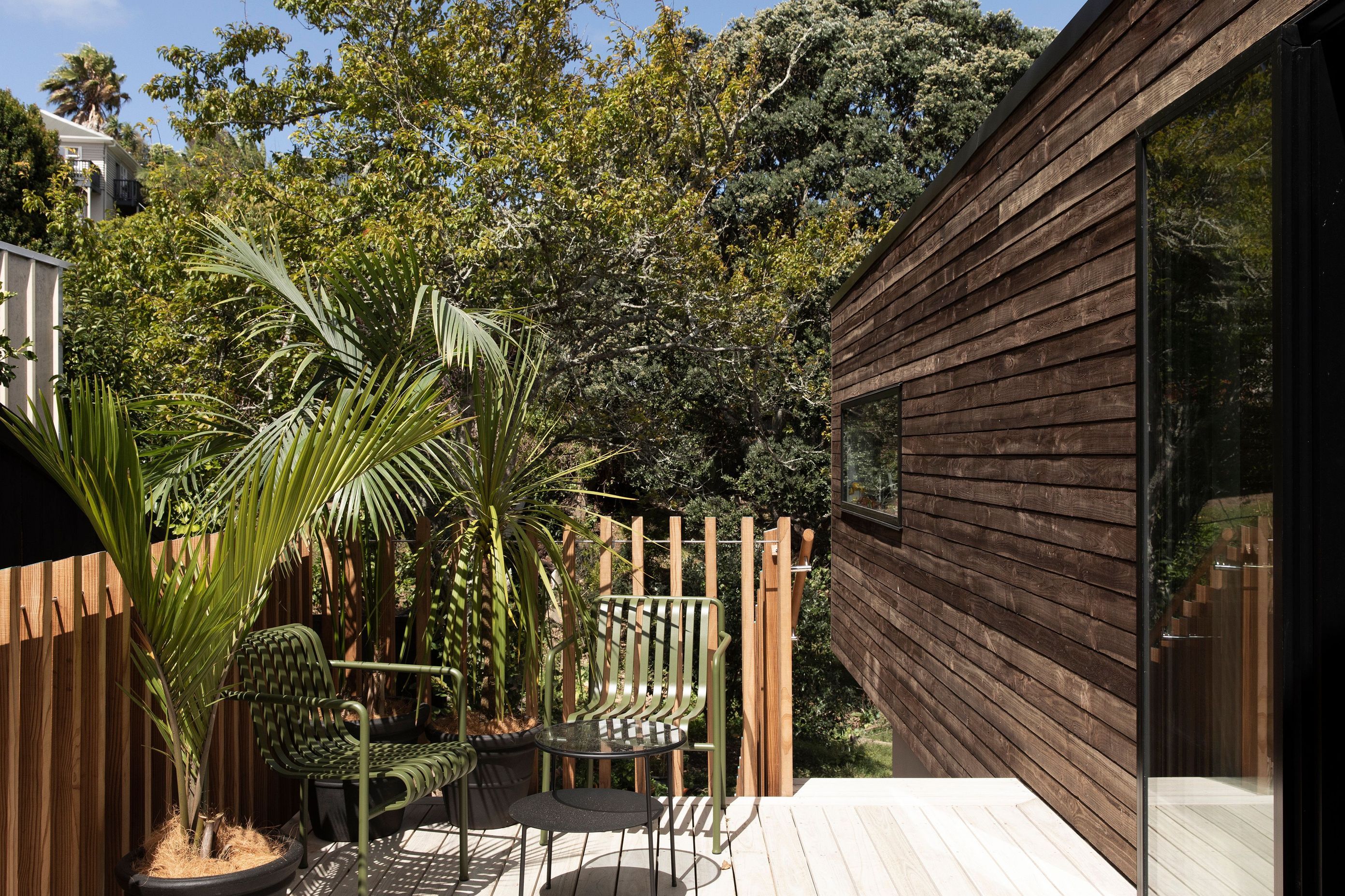 The deck from the kitchen with TOA's balastrade design. The cladding is treated with an iron vitirol coating in favour of an oil-based stain to improve durability and maintenance.