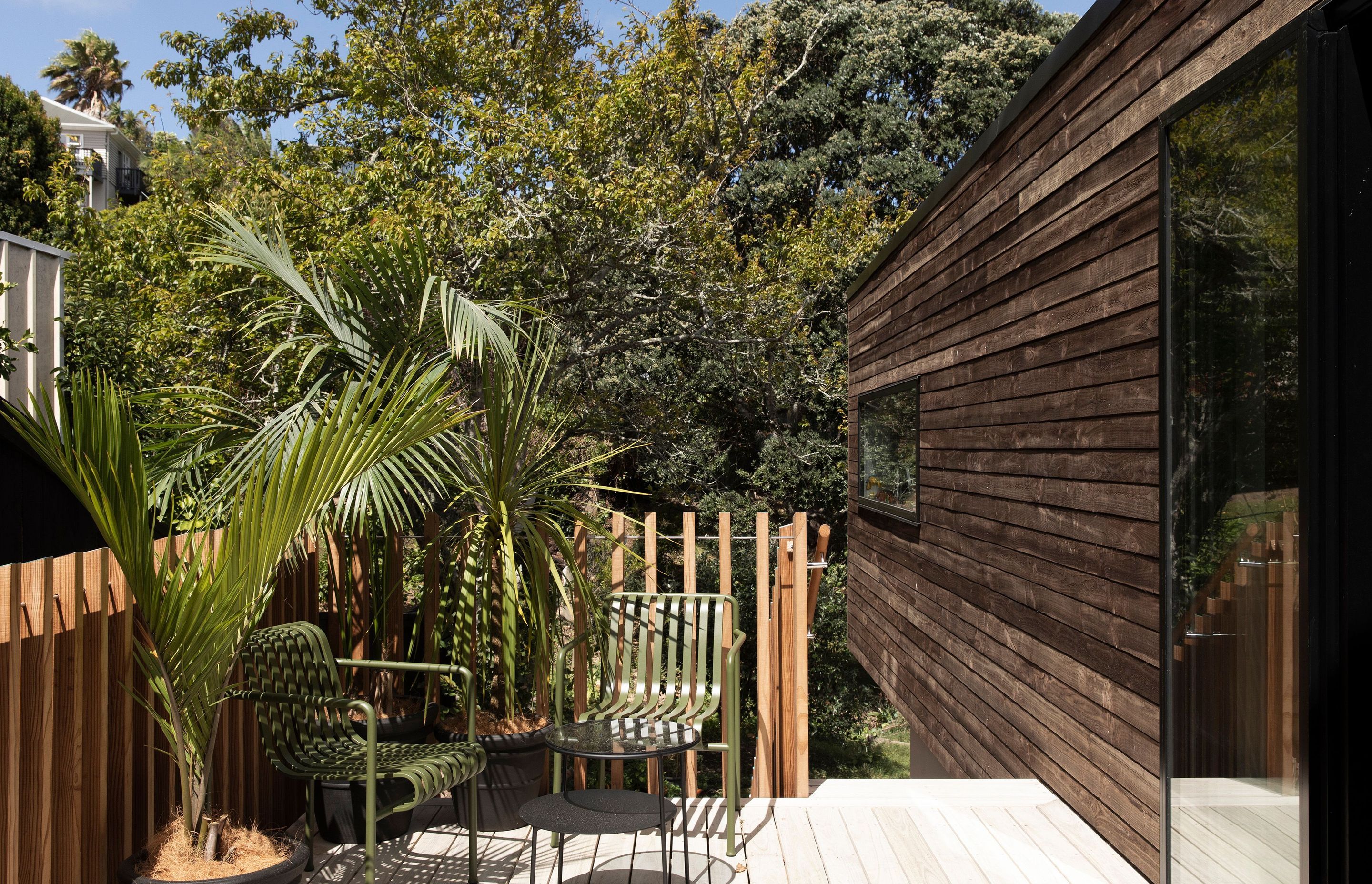 The deck from the kitchen with TOA's balastrade design. The cladding is treated with an iron vitirol coating in favour of an oil-based stain to improve durability and maintenance.