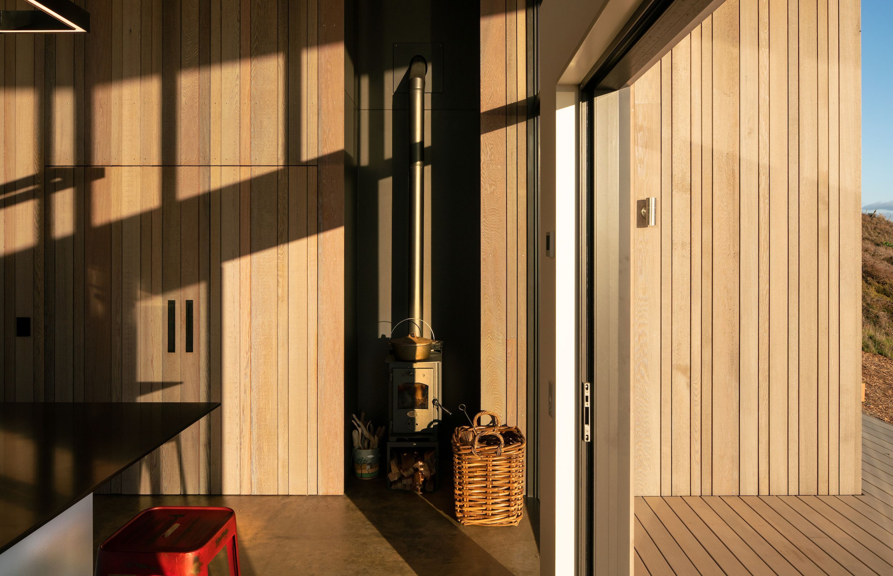 Cedar cladding extends from the exterior to the interior, creating a seamless aesthetic and indoor-outdoor flow.