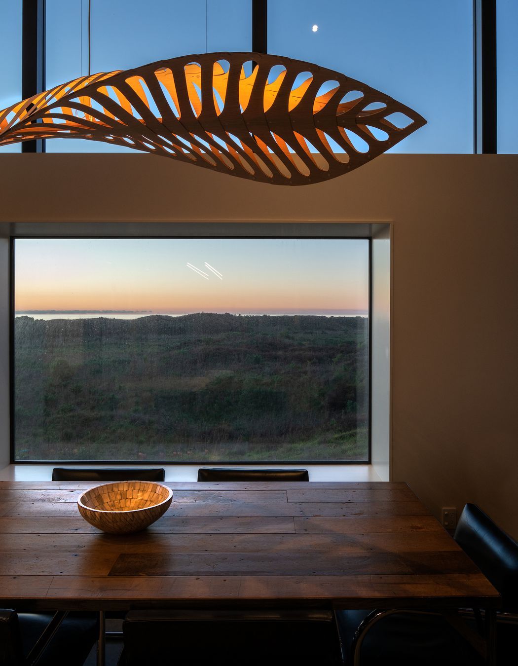 Vignettes of the landscape provide an ever-changing vista, while light and shadow from the feature pendant plays across the interior surface.