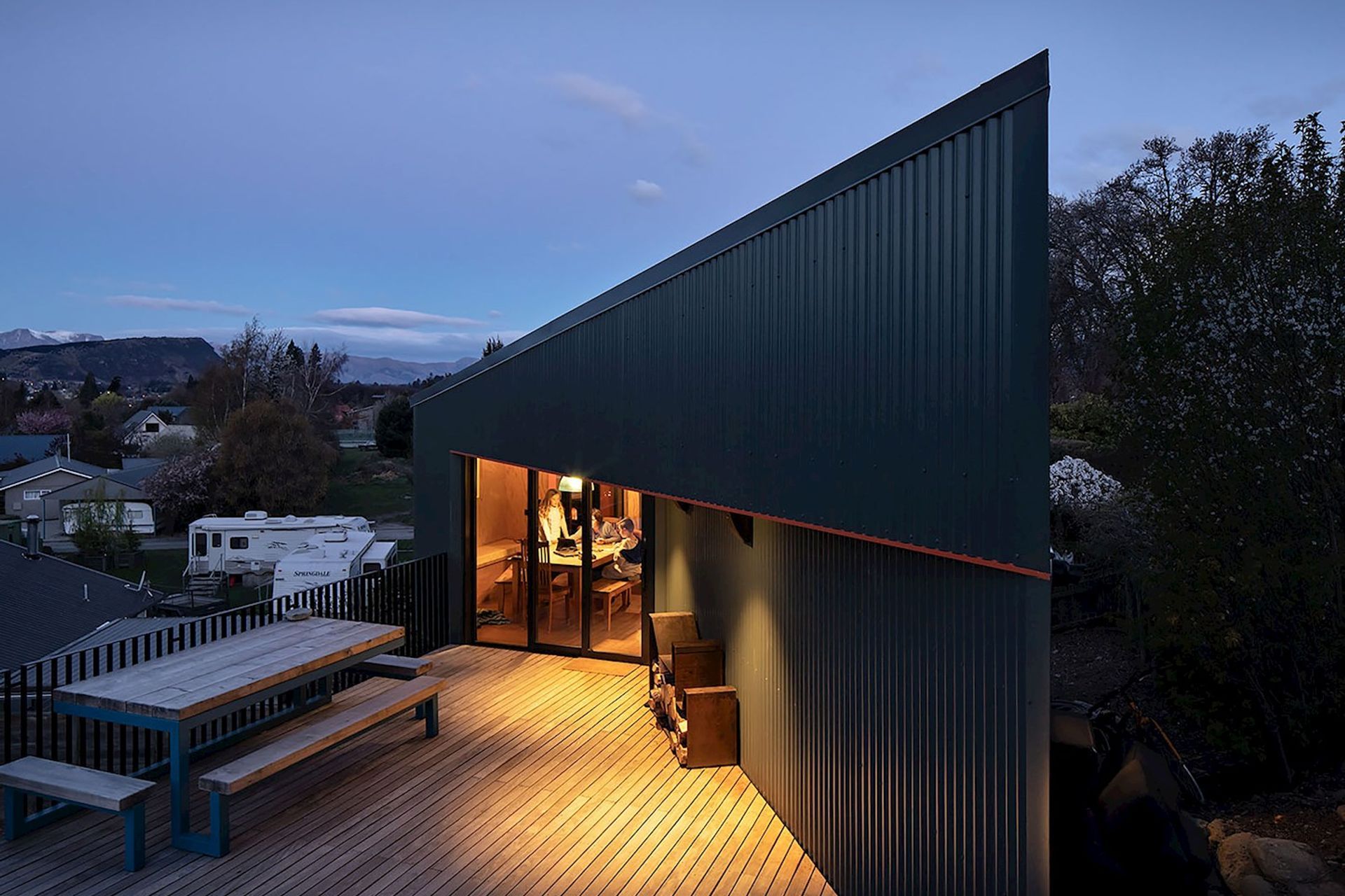 The shape and form of the house is defined by the steep slope and a neighbour's drainage easement under the decking.