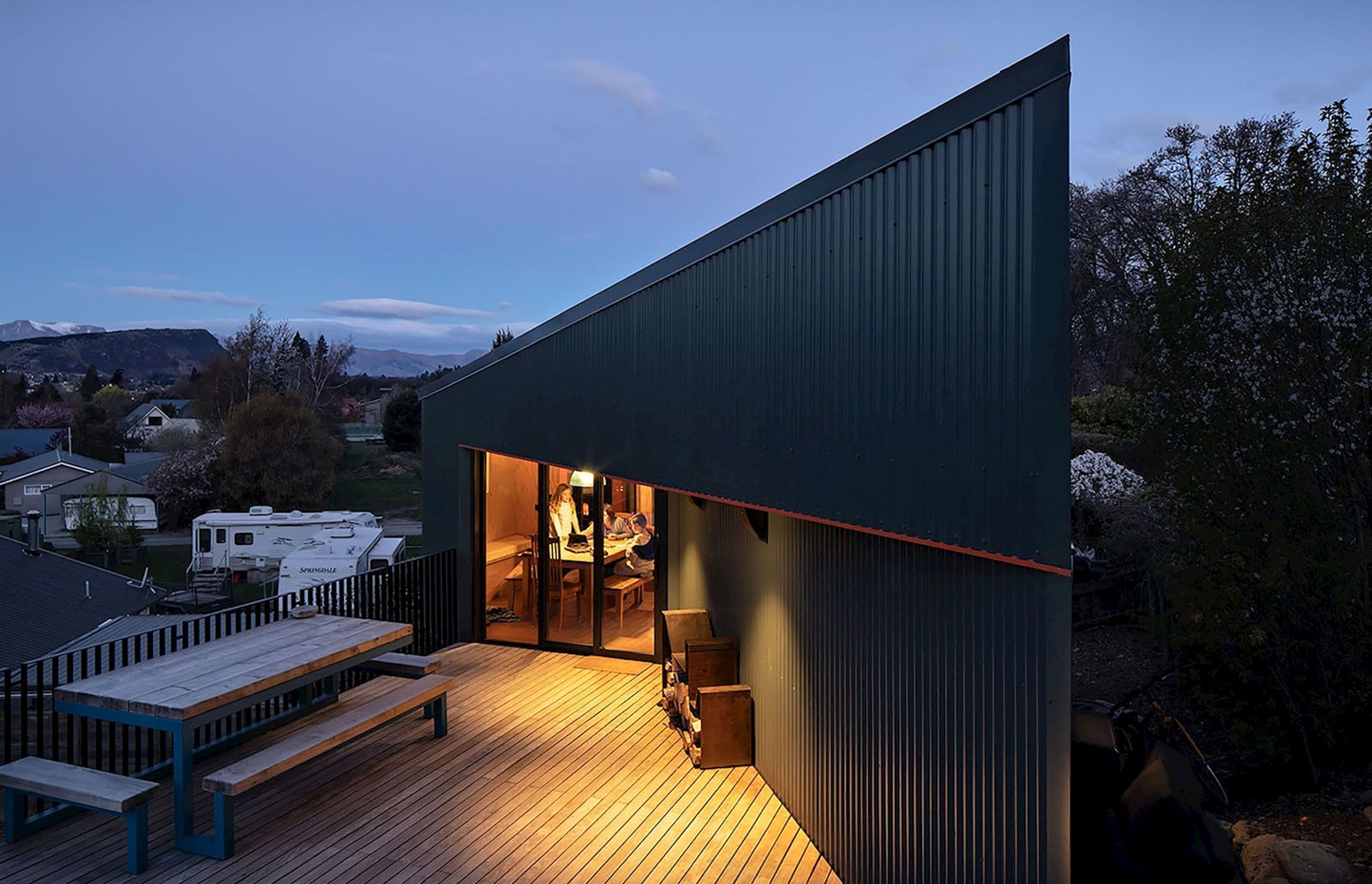The shape and form of the house is defined by the steep slope and a neighbour's drainage easement under the decking.