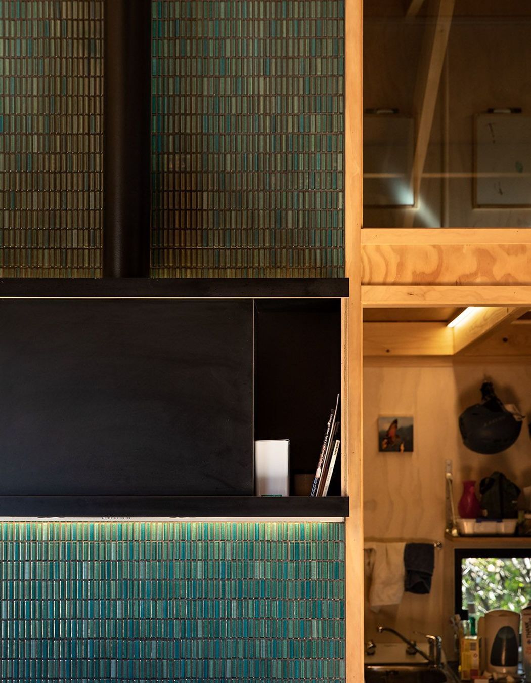 Emerald green tiling perfectly complements the warm timbers of the interior.