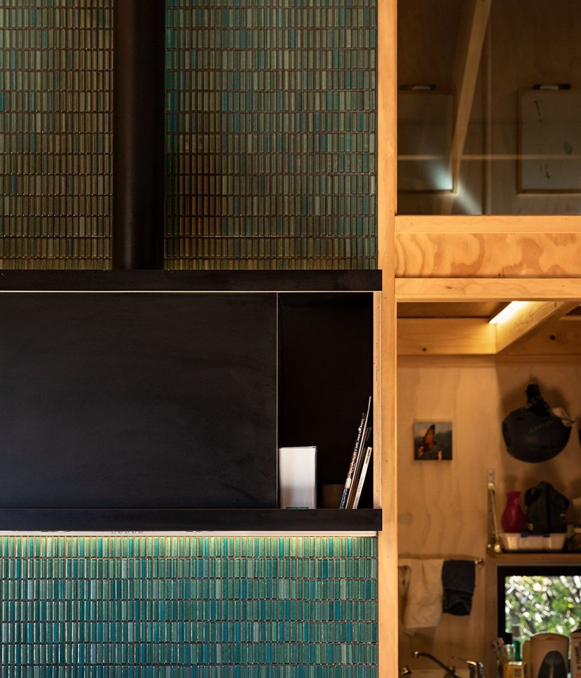 Emerald green tiling perfectly complements the warm timbers of the interior.