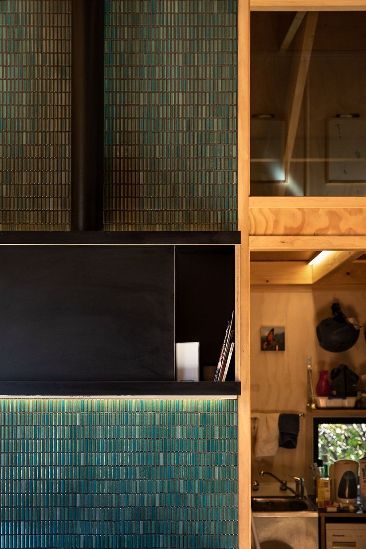Emerald green tiling perfectly complements the warm timbers of the interior.