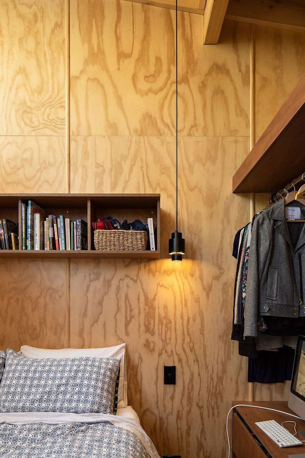 Open shelves in the master bedroom continues the 'humble hut' aesthetic.