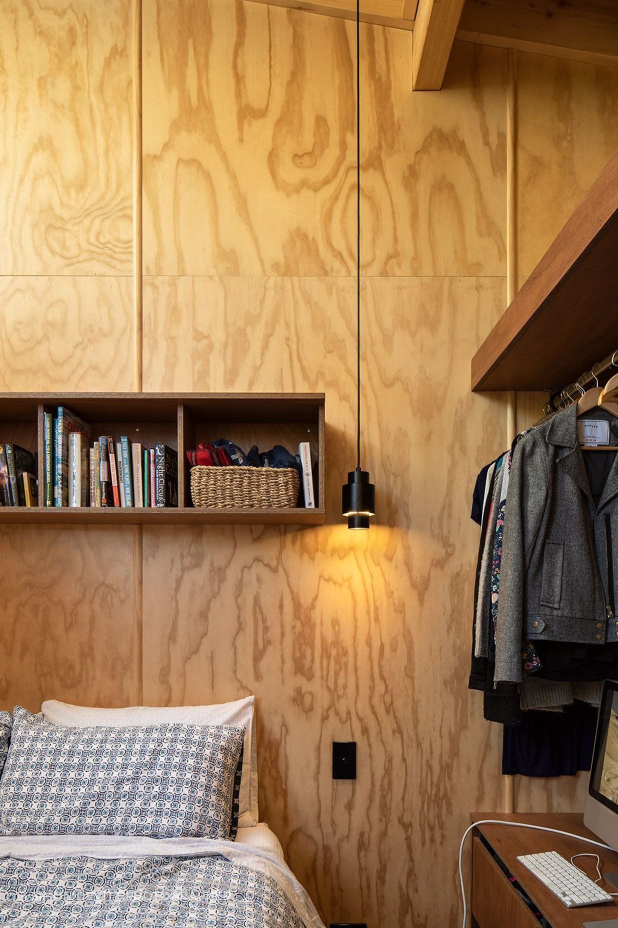 Open shelves in the master bedroom continues the 'humble hut' aesthetic.