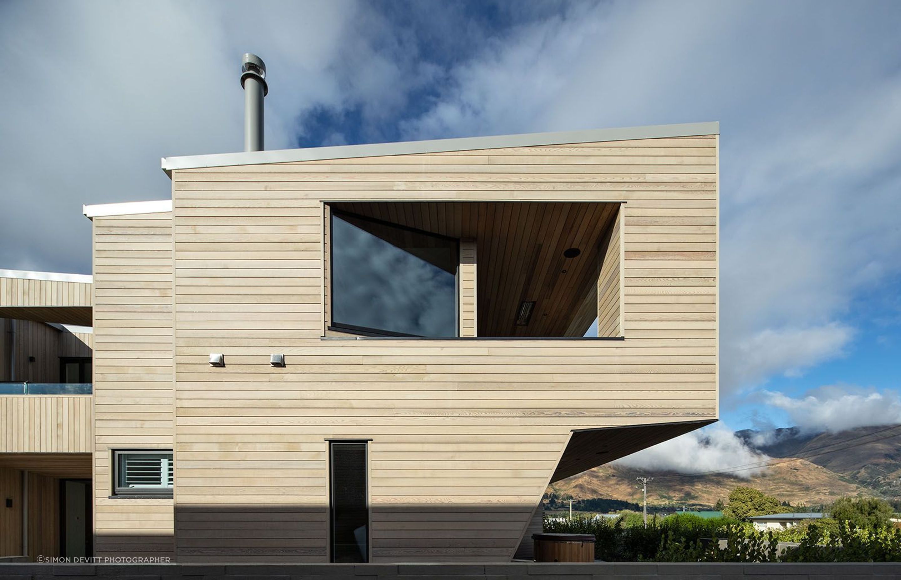 The east-facing elevation shows the cantilevered balcony at the front of the house and the entrance and morning deck (on the left).