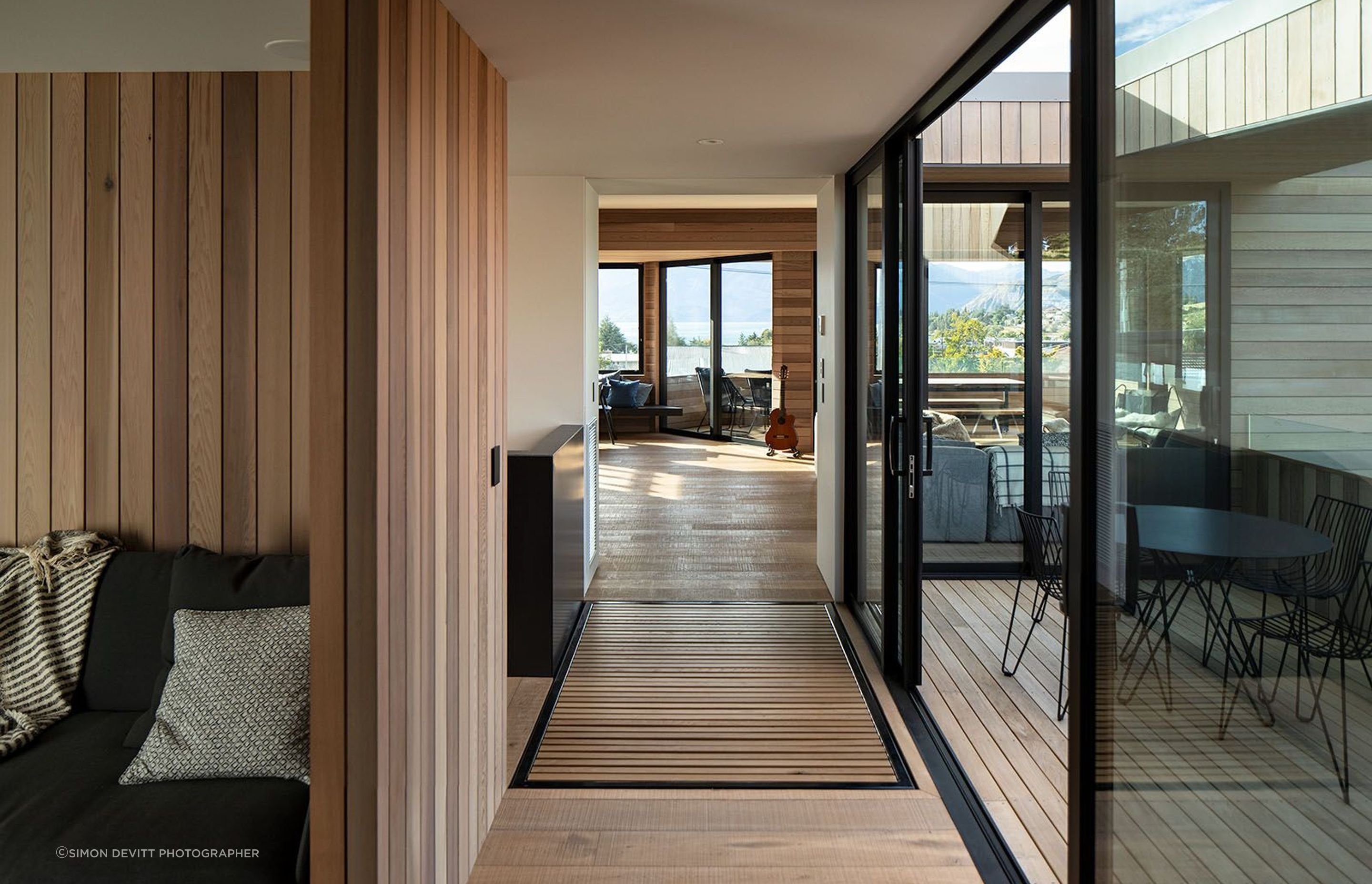 On the upper storey, the corridor leads to the media room and stairwell (left), morning deck (right) and the open-plan living area (centre).