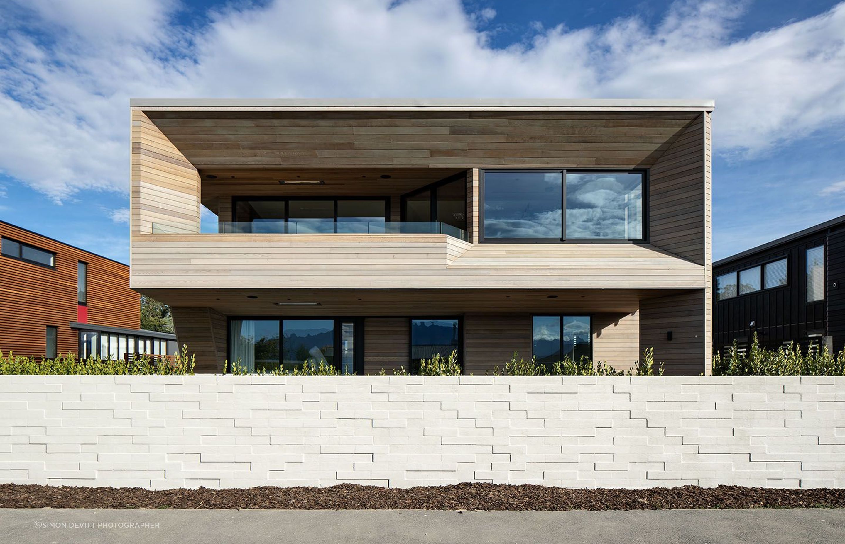 Te Whare Rakau's site offers stunning lake views from the first floor, so the main living spaces and balcony have been placed on the upper level to take advantage of the outlook.