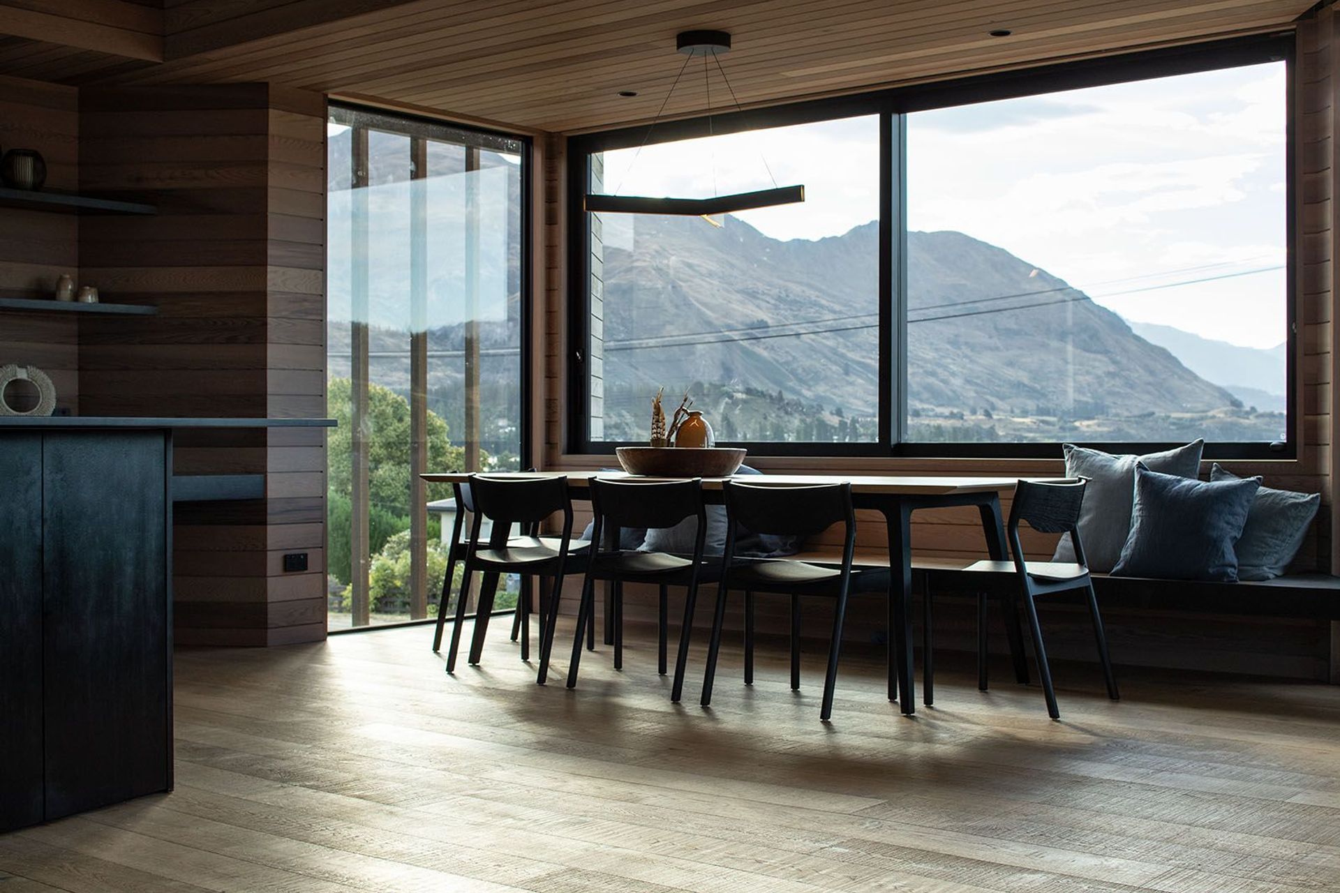 The dining area enjoys dynamic views over the lake and mountain ranges.