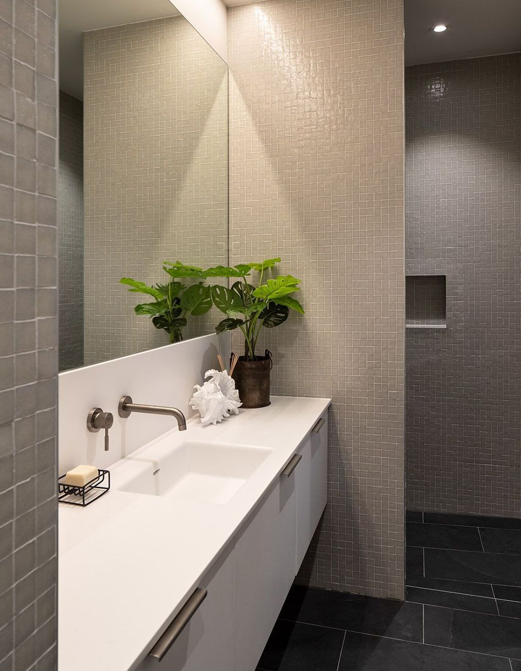 Uneven tiling adds a textural effect to the bathroom walls.