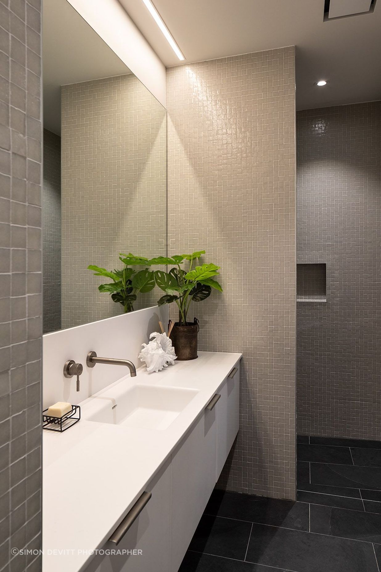 Uneven tiling adds a textural effect to the bathroom walls.