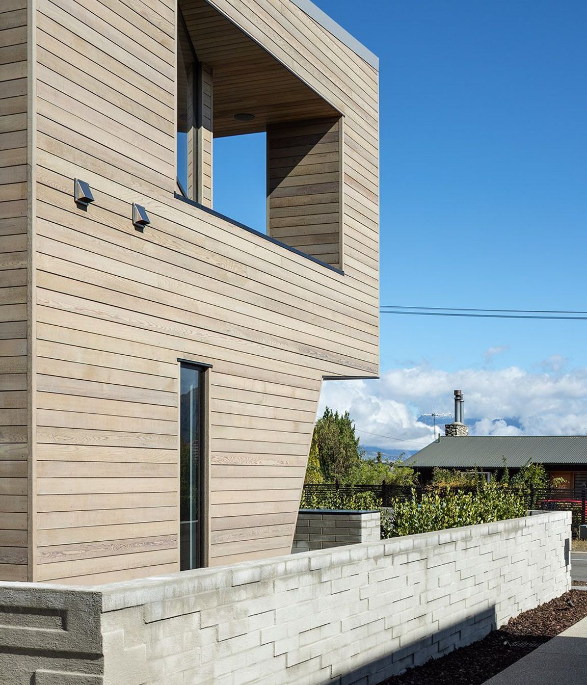 The exterior wall in half-width concrete blocks has been arranged haphardly to create a textural surface.
