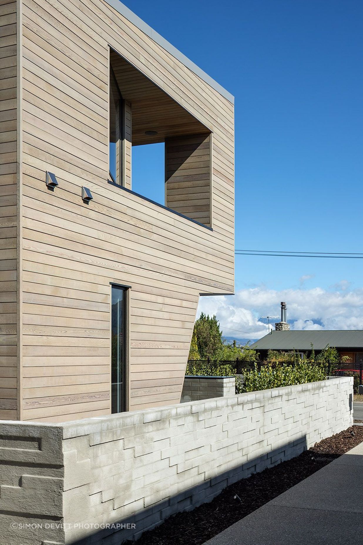 The exterior wall in half-width concrete blocks has been arranged haphardly to create a textural surface.