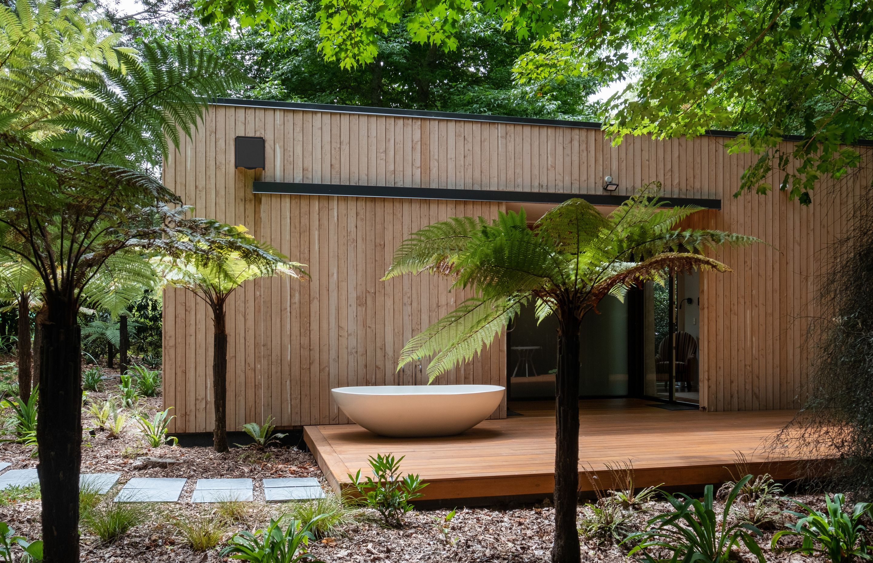 By placing the bathtub at the entrance to the cabin, the architect says visitors are immediately made aware of the connection to the surroundings that the design establishes.