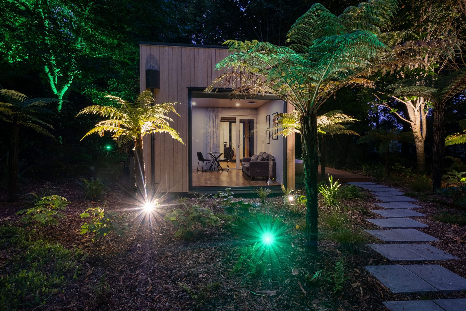 The owner's installation of extensive lighting throughout the garden adds another dimension to the view from the lounge area when night falls.
