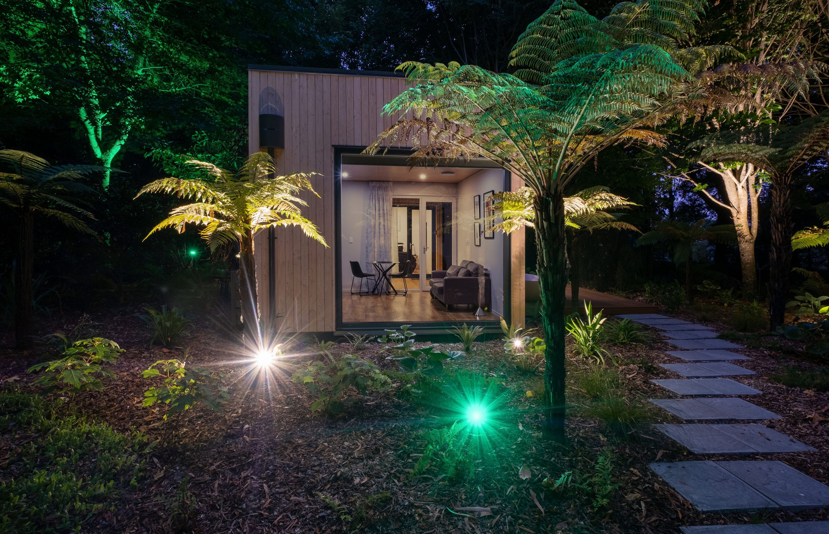 The owner's installation of extensive lighting throughout the garden adds another dimension to the view from the lounge area when night falls.