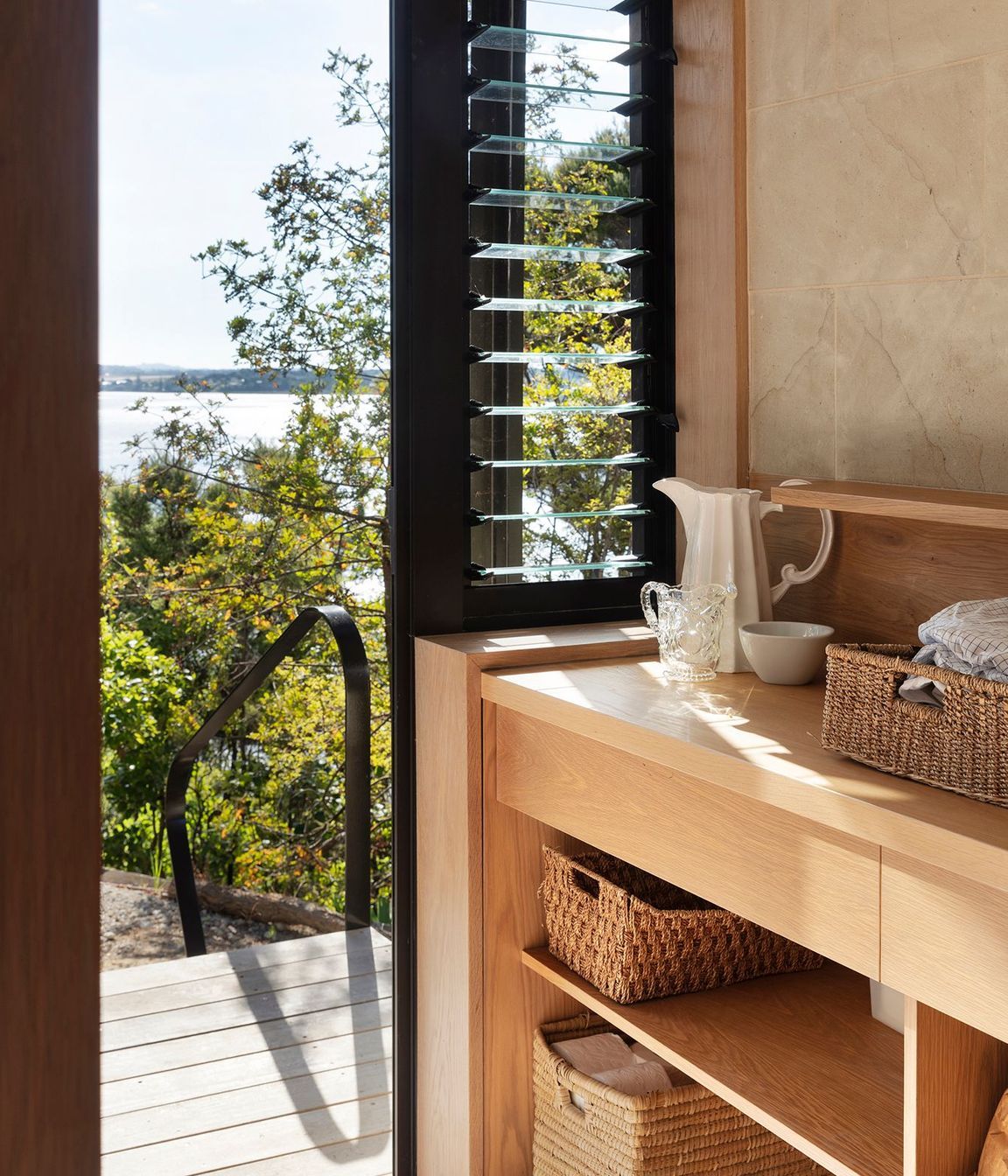 The timber-rich laundry has louvred windows for extra ventilation.
