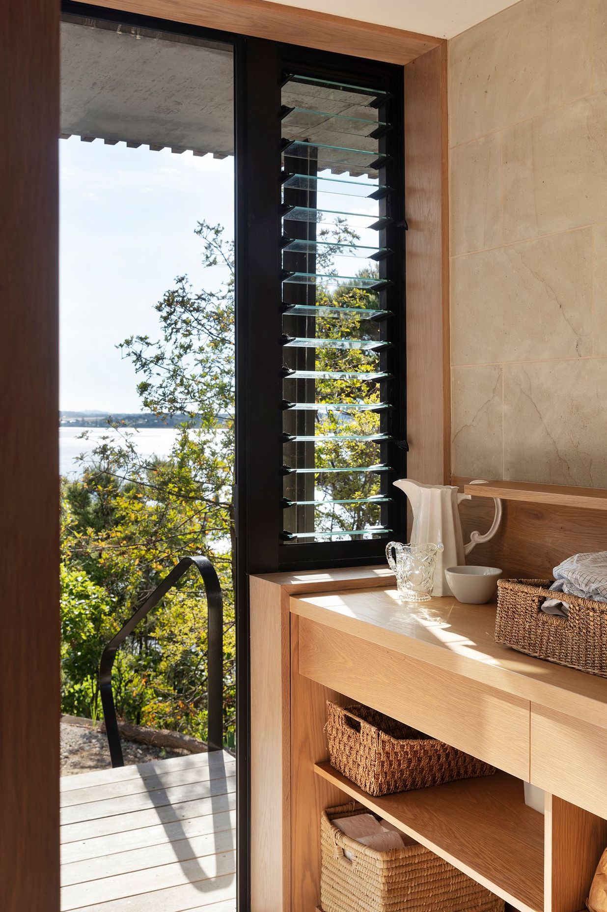 The timber-rich laundry has louvred windows for extra ventilation.