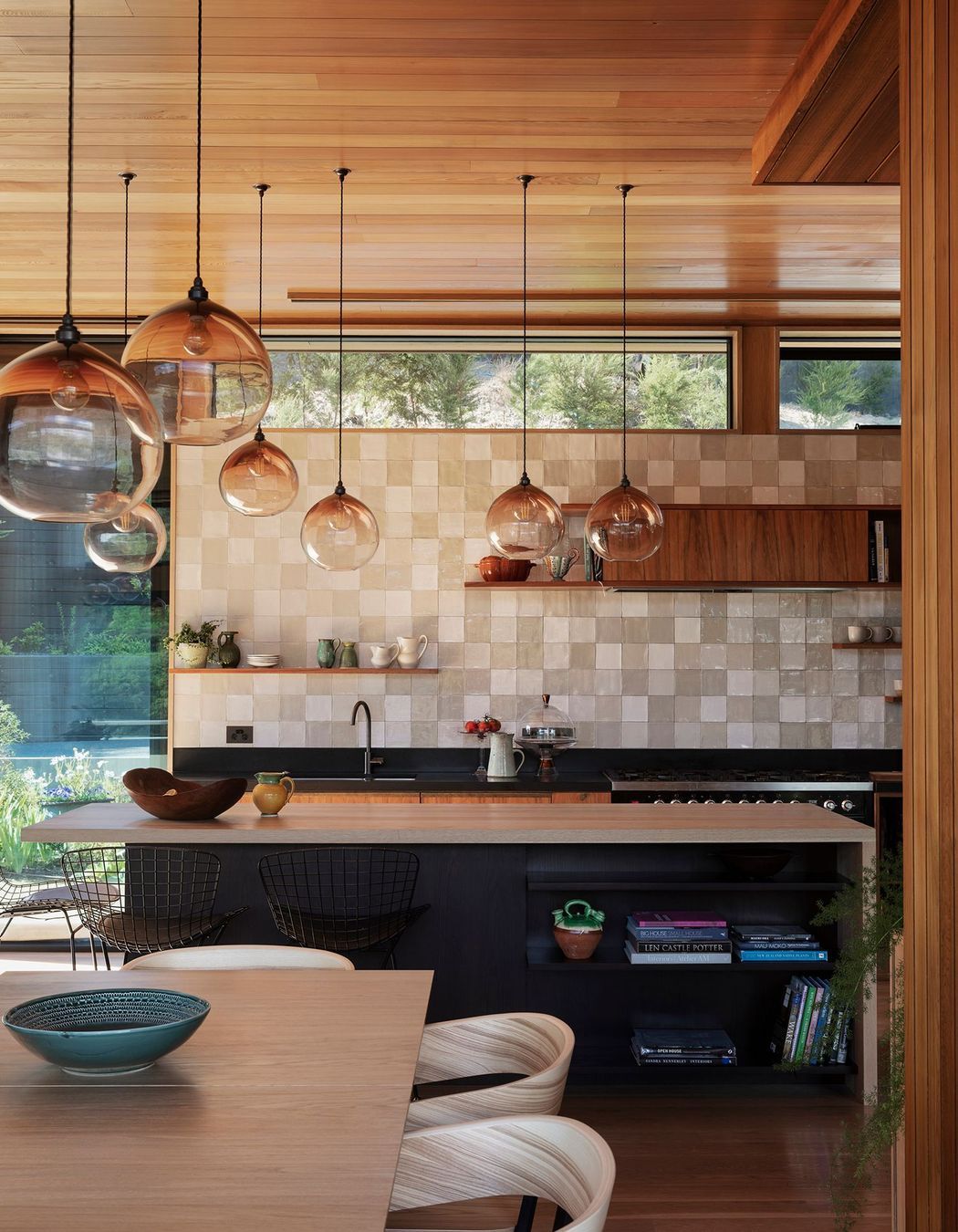 Handblown pendent lights speckle the open-plan living space and tie it together.