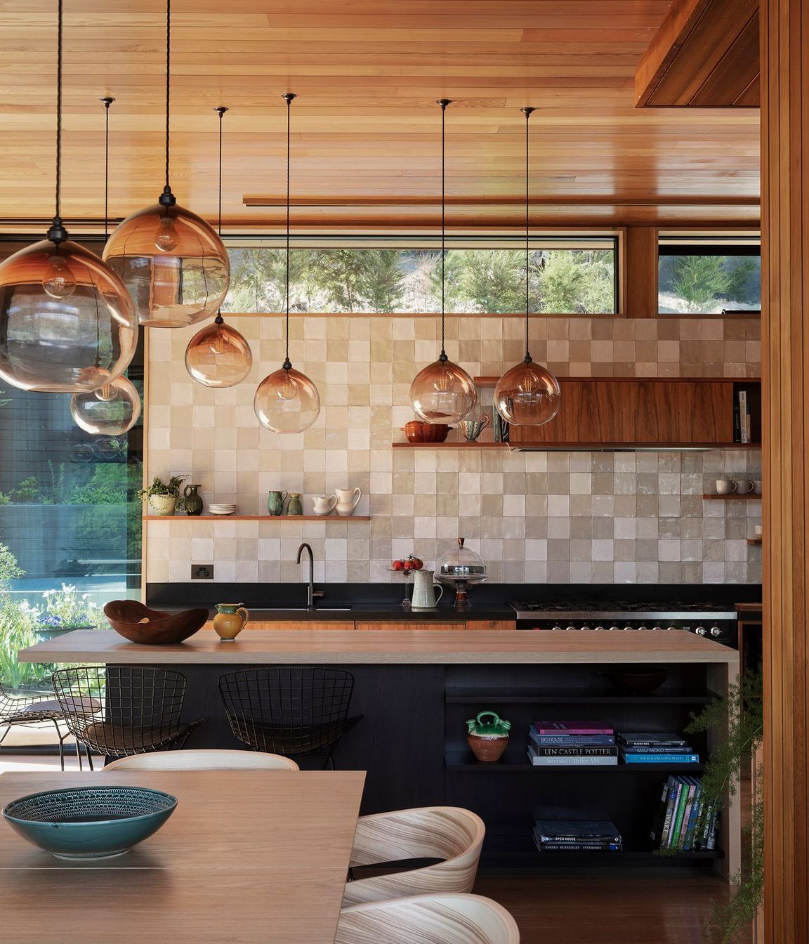 Handblown pendent lights speckle the open-plan living space and tie it together.