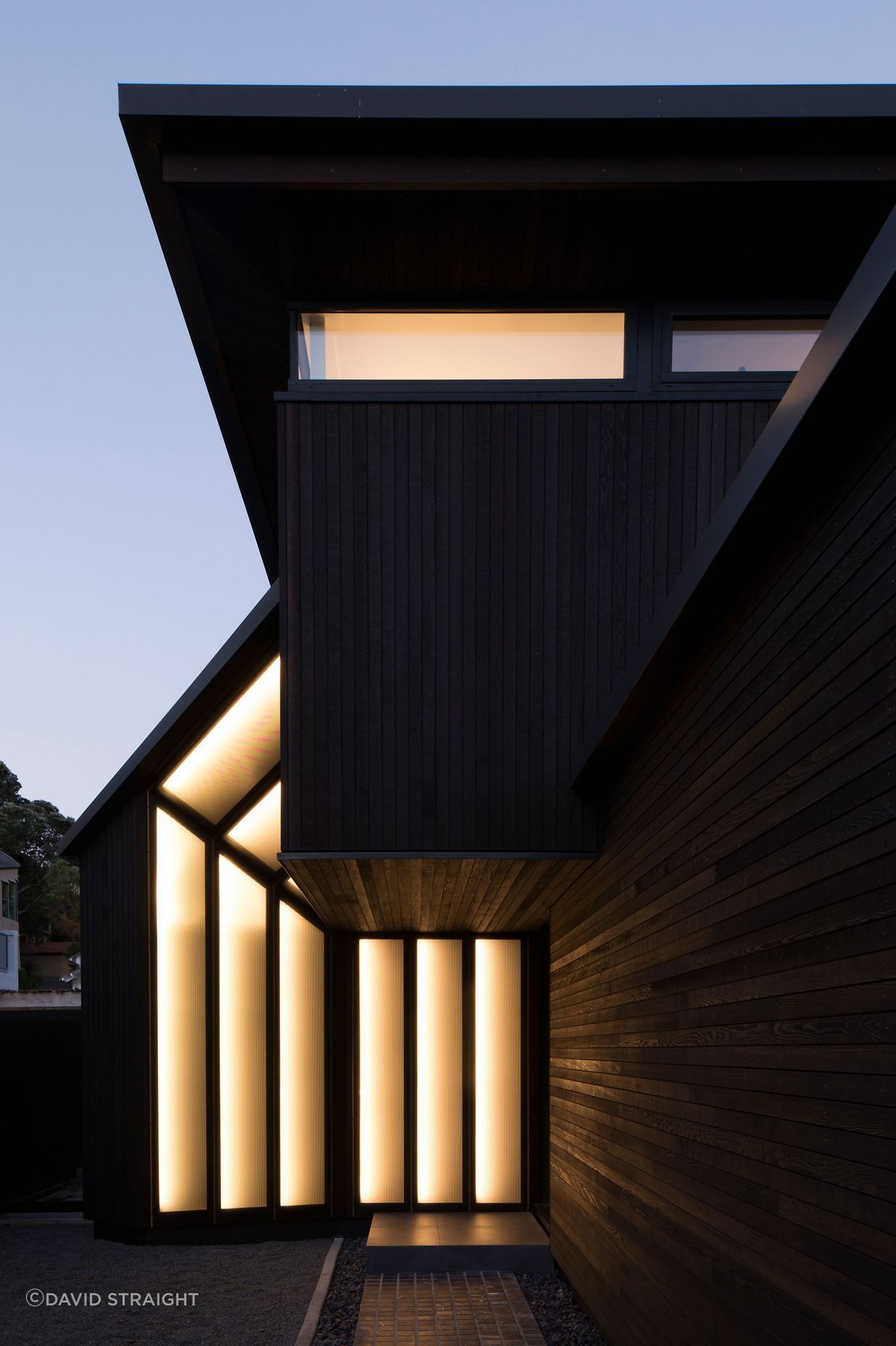 The entrance has perforated metal panels defined with gold piping when lit up at night.