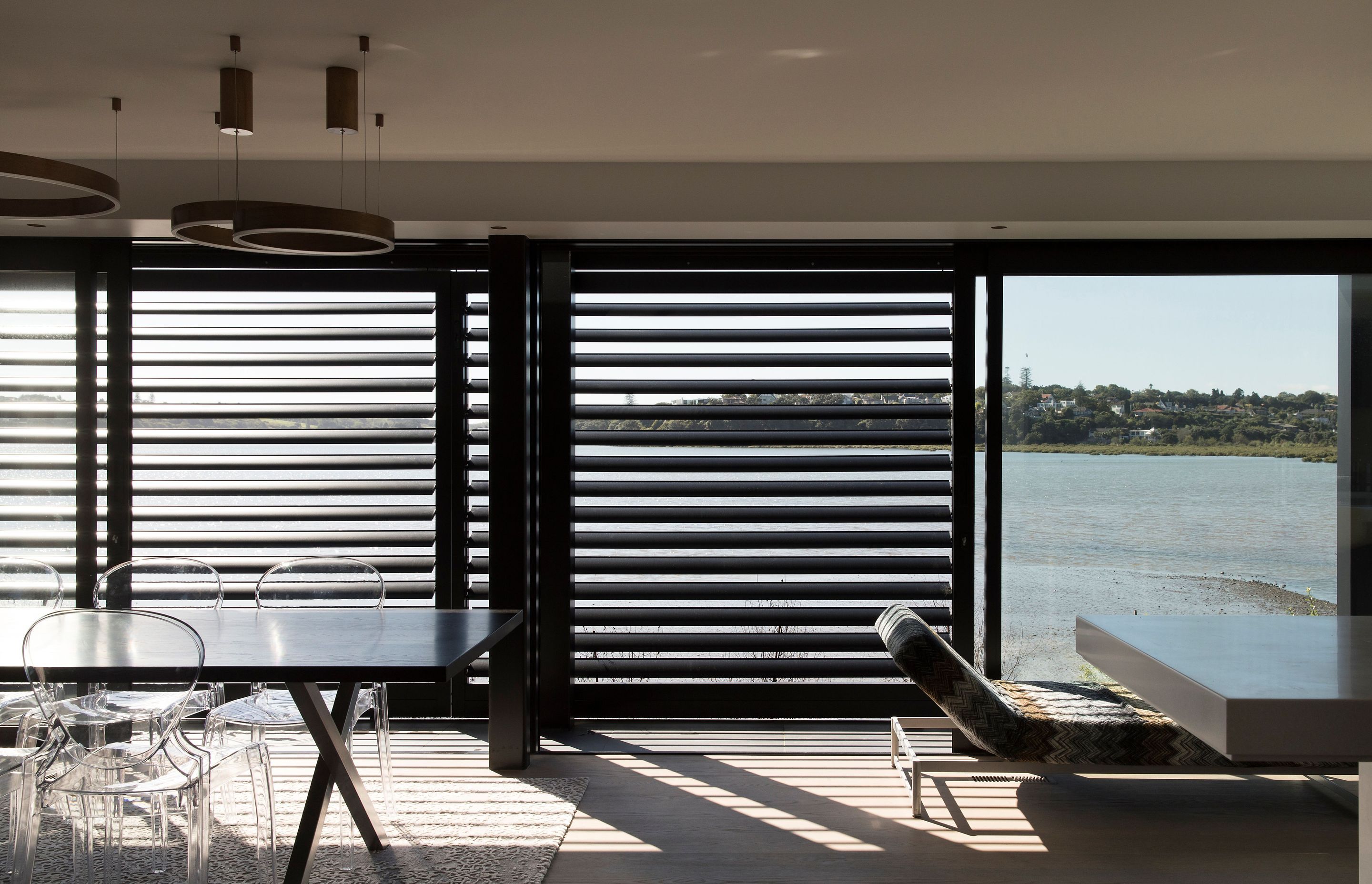 Louves help to shade the interior from the northern sunlight and create a horizontal pinstriped effect on the exterior and in the shadows cast on the floor.