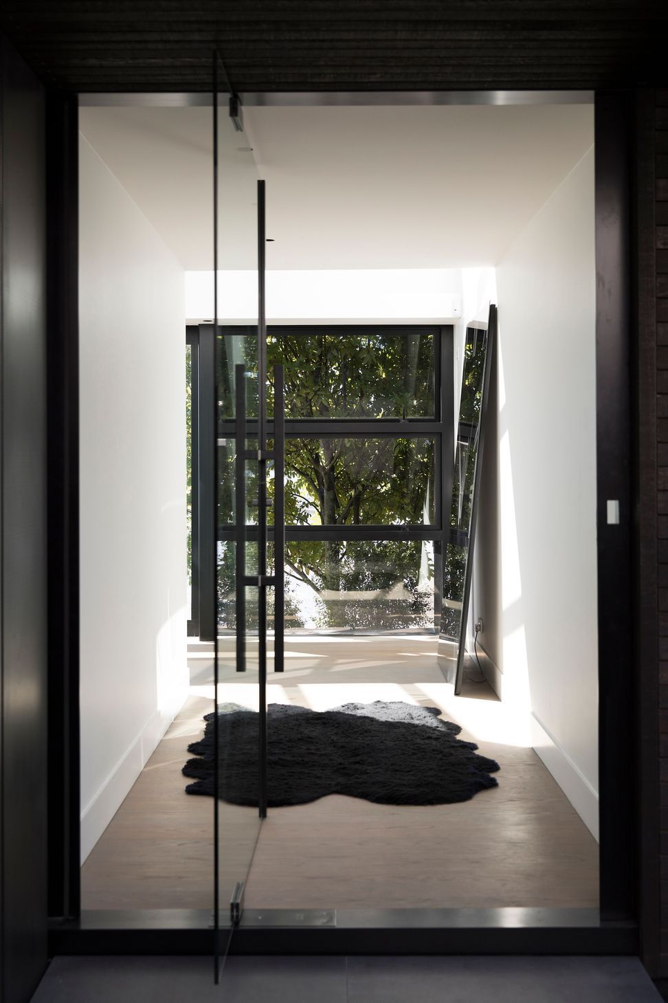 The main entrance enjoys a view of trees on the other side of the house.