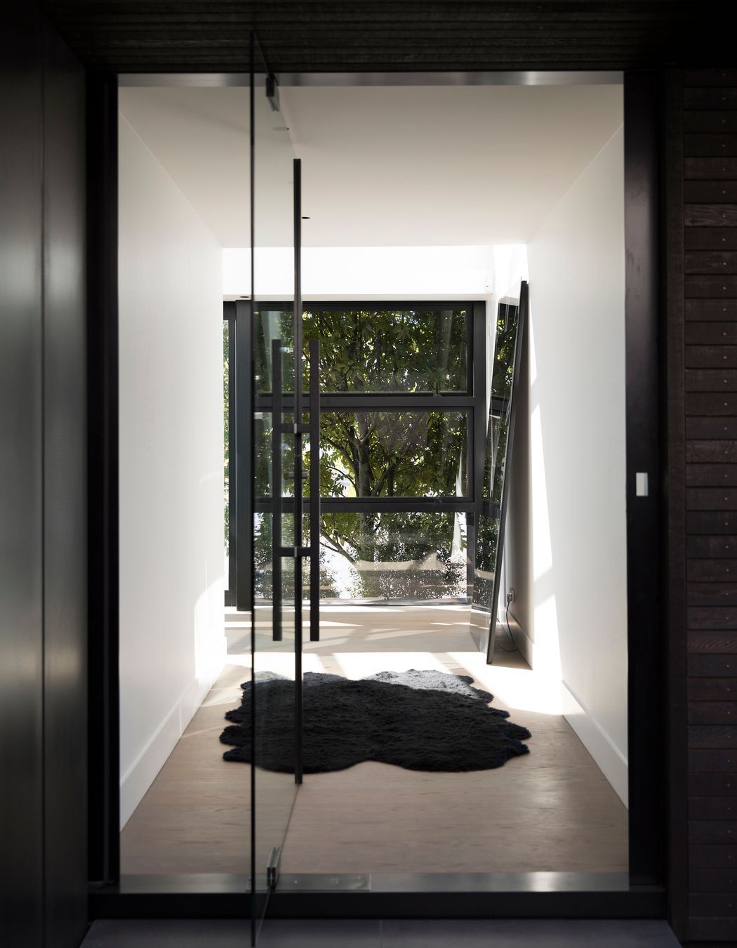 The main entrance enjoys a view of trees on the other side of the house.