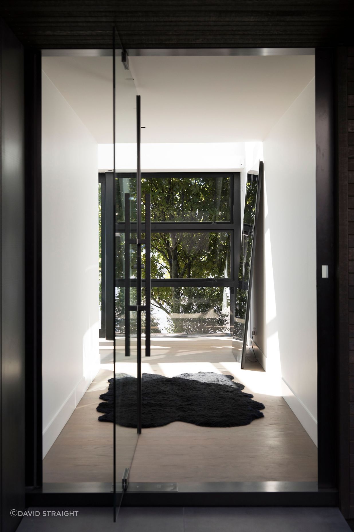 The main entrance enjoys a view of trees on the other side of the house.