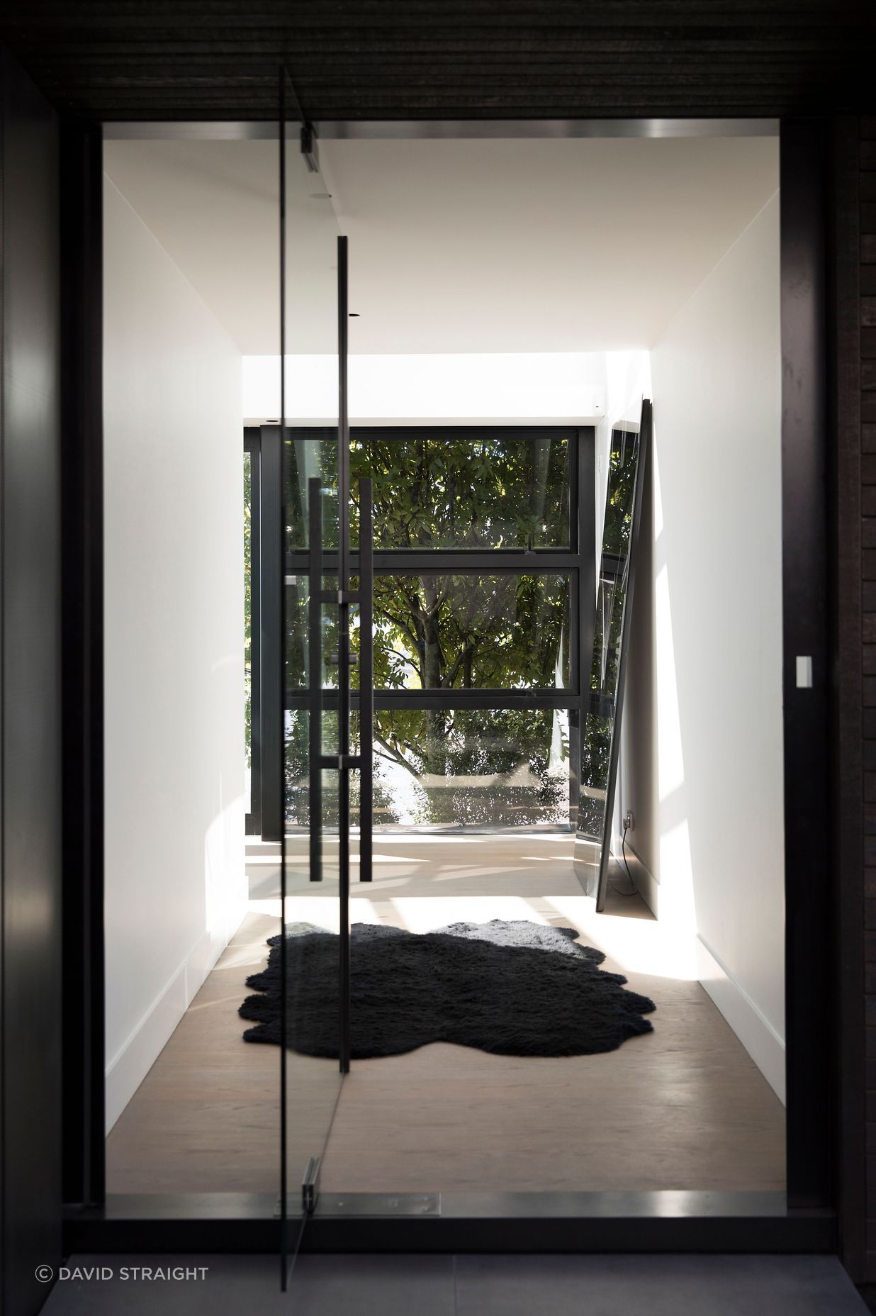 The main entrance enjoys a view of trees on the other side of the house.